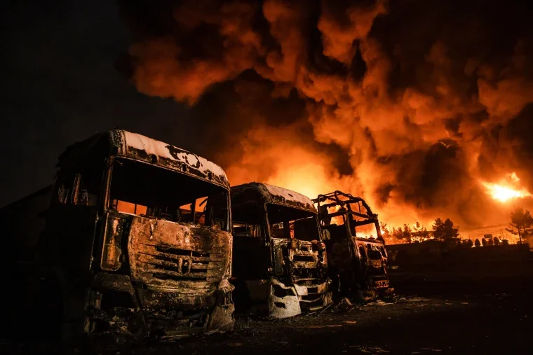 Camiones calcinados frente al depósito petrolero de Shahran, en Teherán, durante el incendio provocado por los ataques de marzo de 2026.