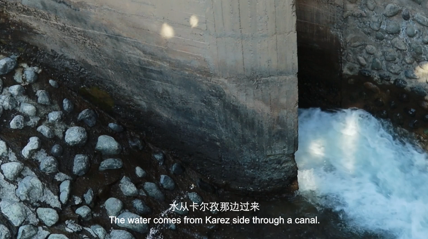 Water flowing from a traditional Karez canal in Turpan, Xinjiang, an ancient underground irrigation system.