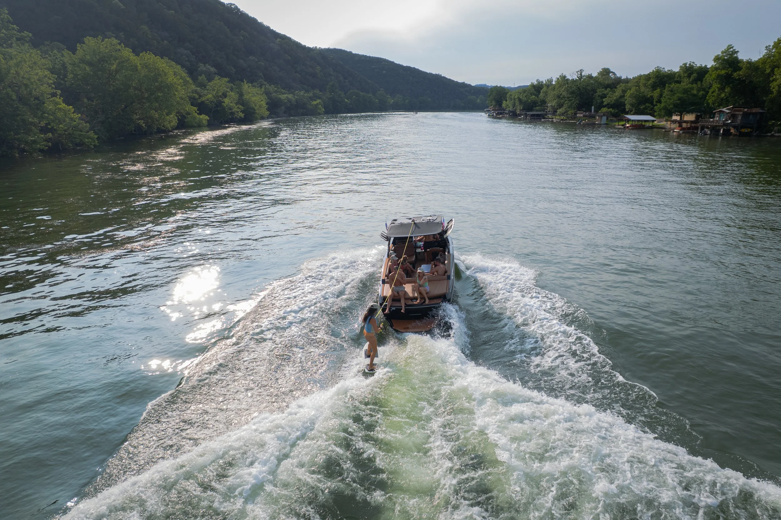 Beginner women learning how to wake surf on Lake Austin