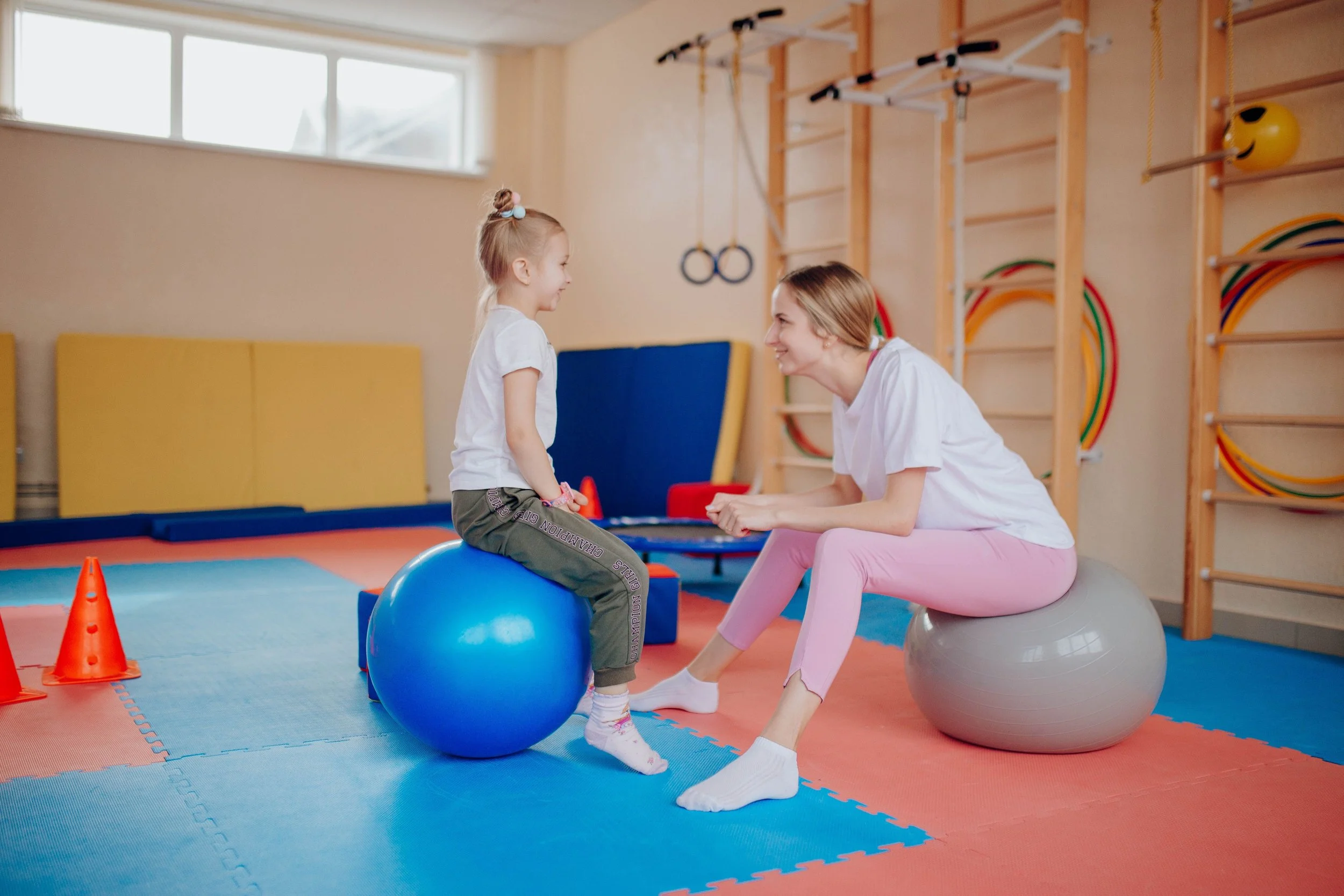 Child receiving physiotherapy while sitting on a therapy ball at London Harley Street Practice