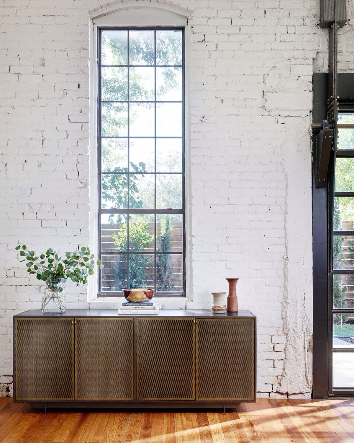 Angular iron framing welcomes front-open cabinetry of perforated brass, as ring-style hardware add a unique finishing touch.  The sideboard is a must see and also available to order in all black.

73w 18d 30h

#districtchicago #shopsmallbusiness #sho