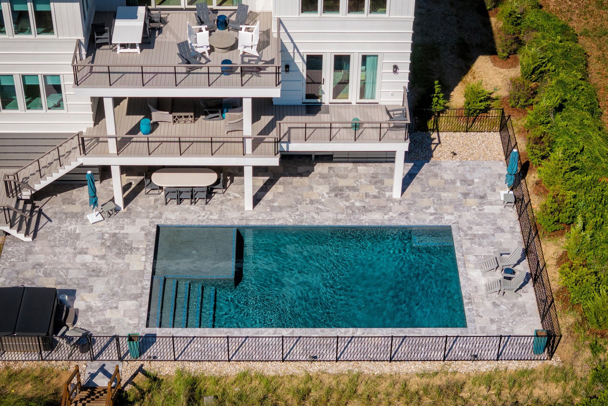 There's no better way to spend your summers than by the water ☀ 

This pool was carefully planned and built to last, with a strong foundation and meticulously handled details. Finished with @wetedgetechnologies  Pebble Plaster, this pool offers a cle