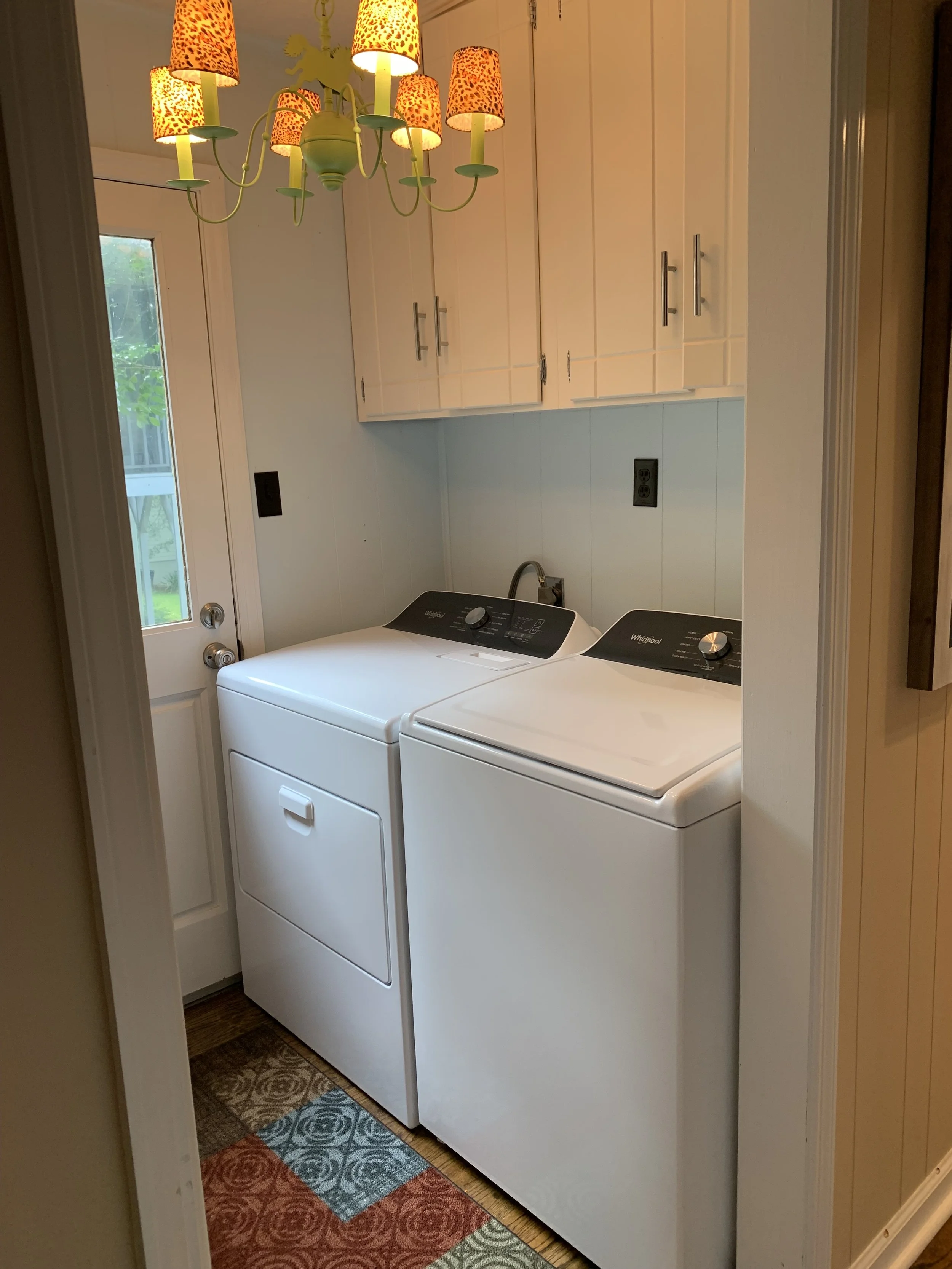Laundry room off kitchen with washer and dryer.