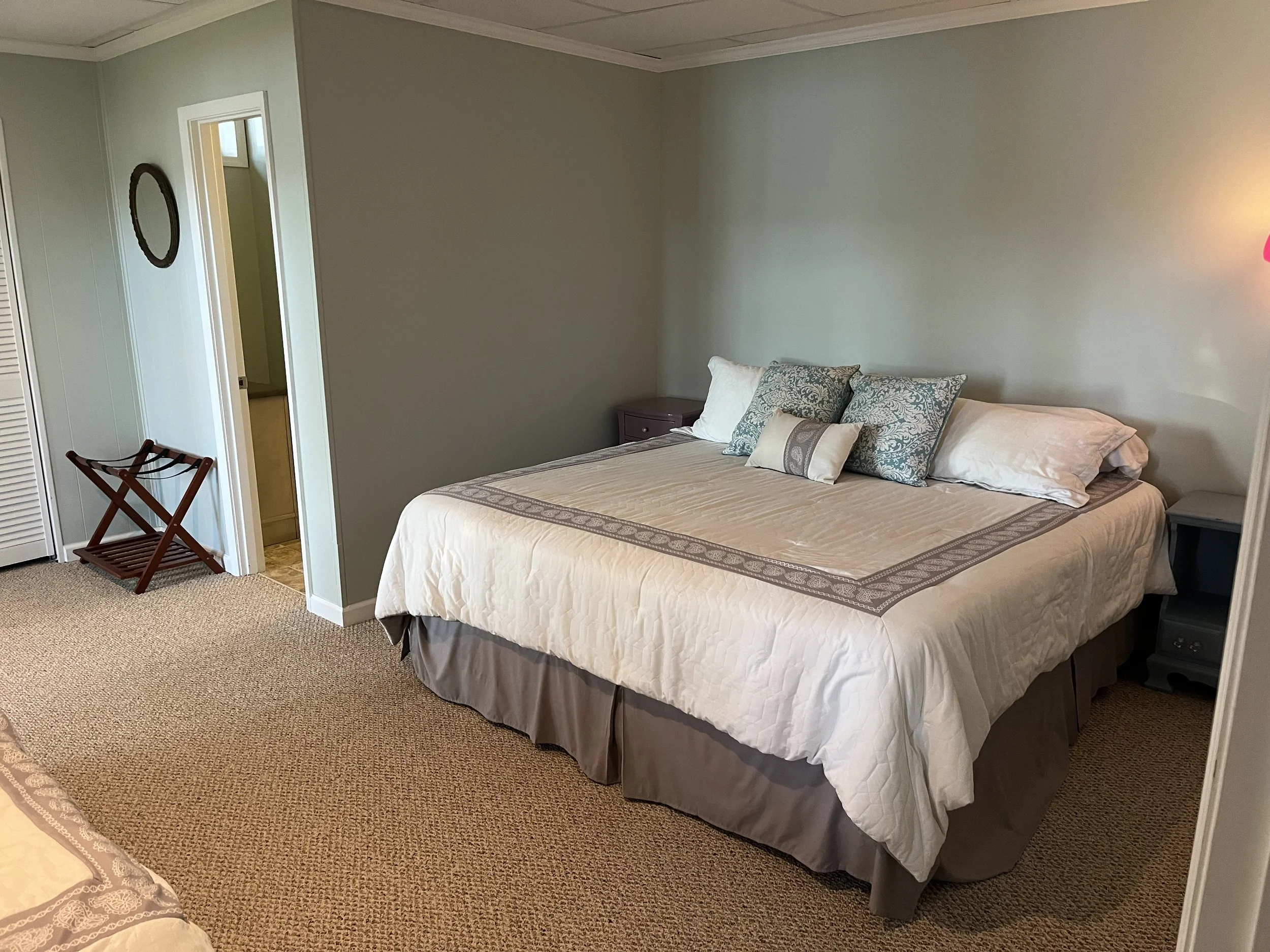 Bedroom #4 downstairs with sliding glass door to porch at ground level.