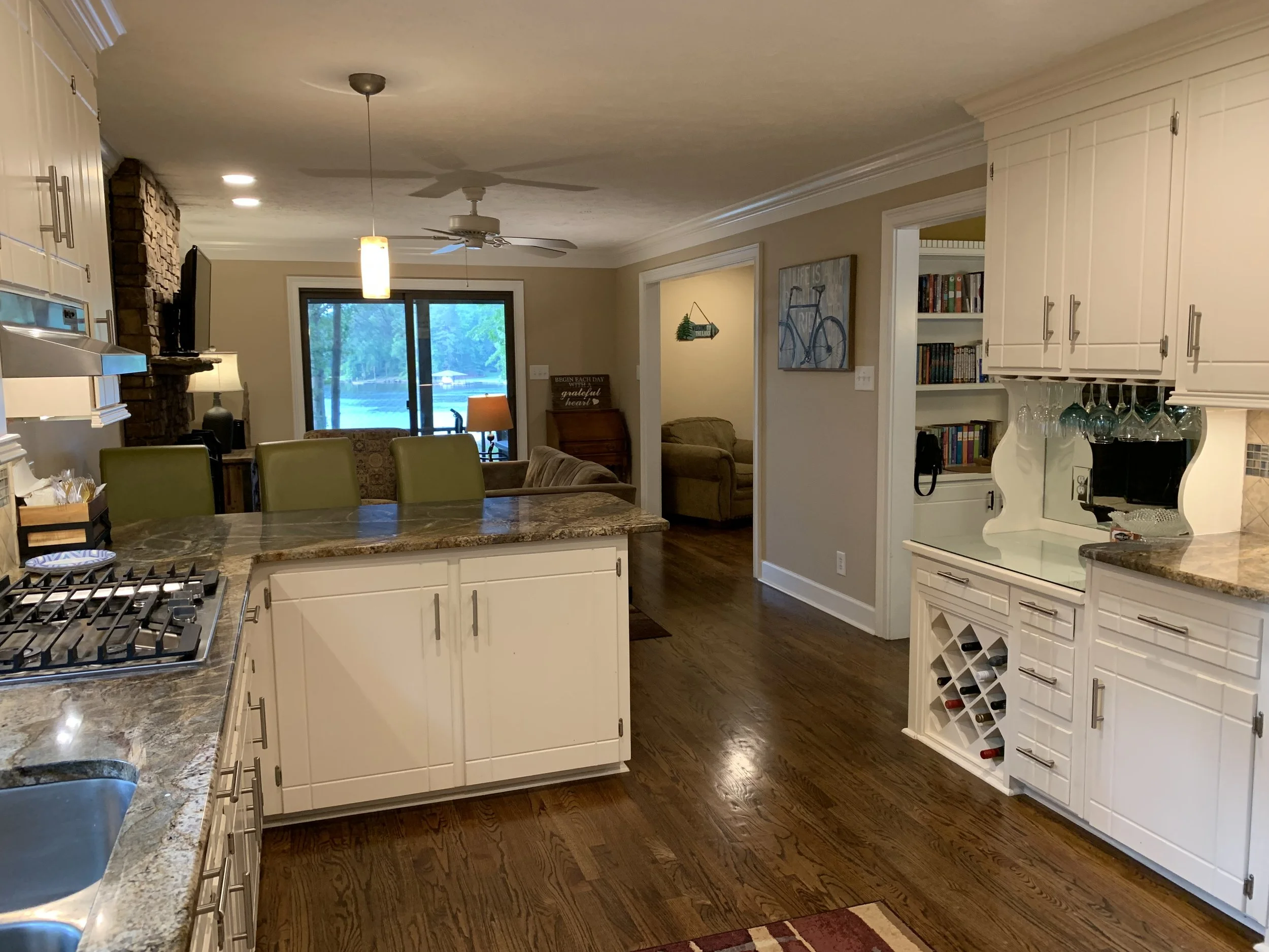 Kitchen with gas cooktop, oven, microwave, refrigerator, and dishwasher opens to sitting room.