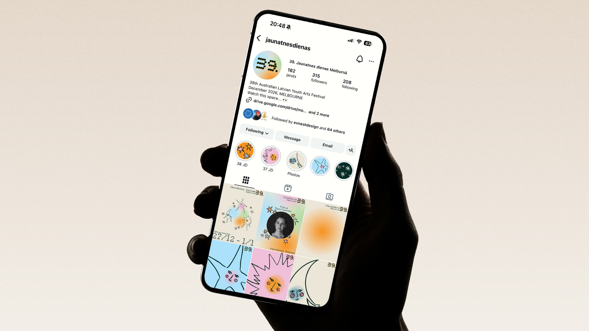 A person holding a smartphone displaying an Instagram profile with colorful artistic posts and profile information.