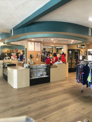 Inside a retail store with checkout counters, customers, and display racks.