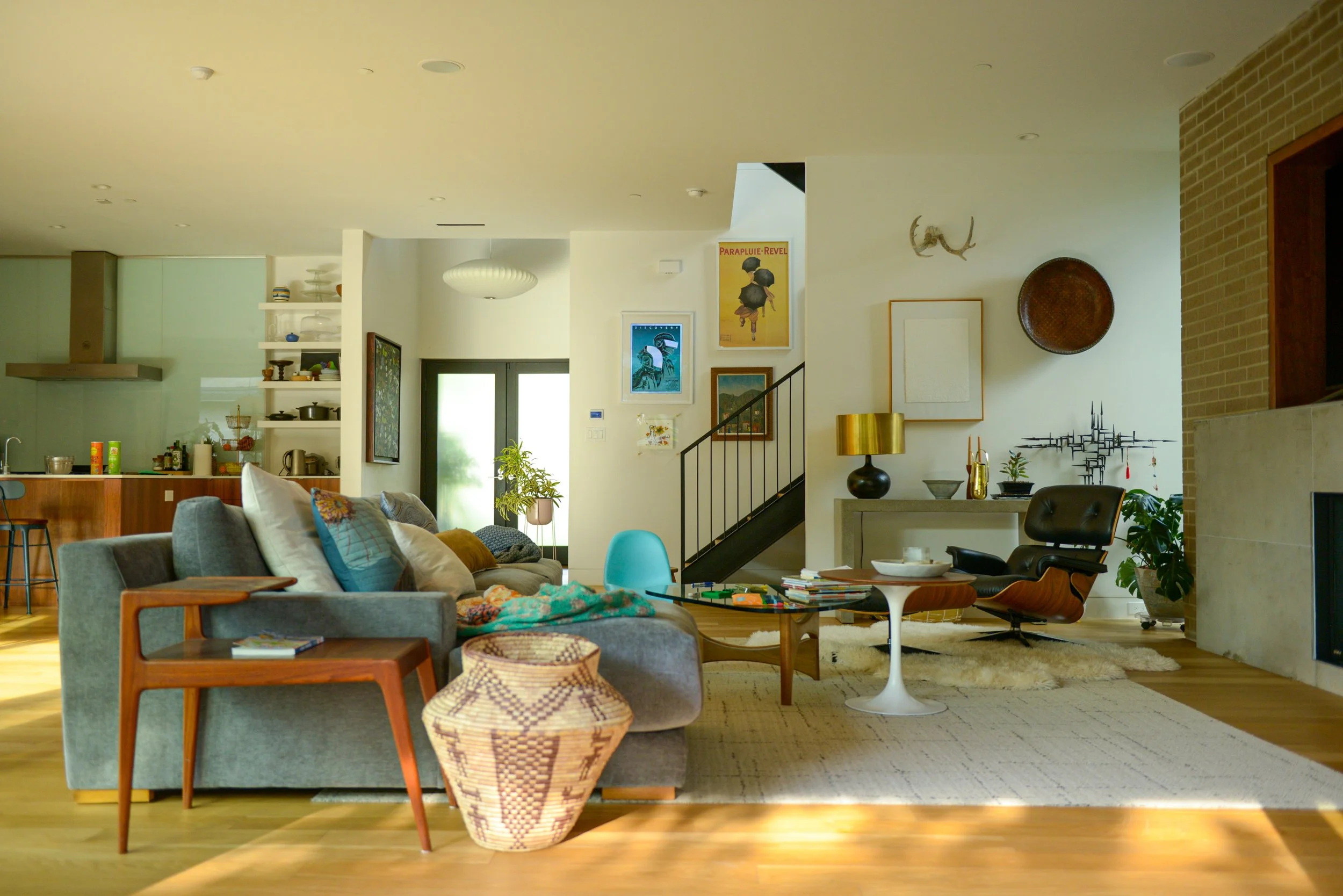 Light-filled living room and kitchen with natural wood accents and collected furnishings