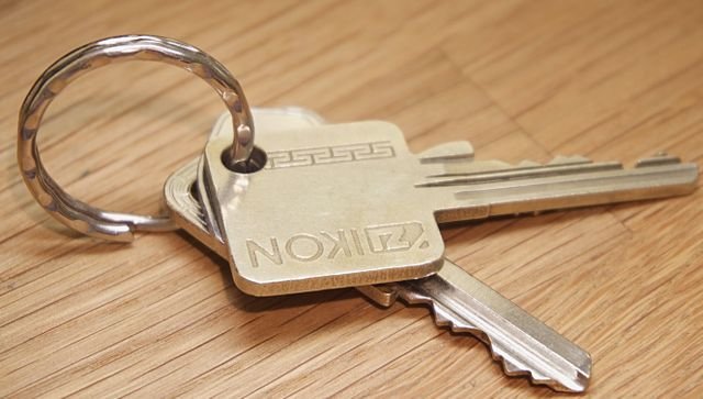A set of house keys resting on a wooden table, representing an inherited property moving through the probate process in North Carolina.