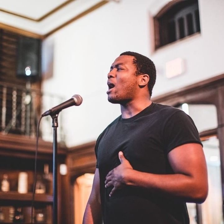 Photo of Ryan preforming slam poetry live. Photo by Michael Clemente in Omaha, Ne