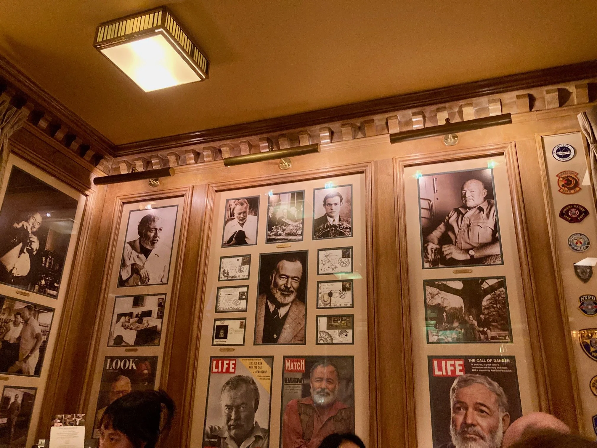 What does it mean to be a famous writer? Perhaps it means that the hotel whose bar you used to frequent names a bar after you and people line up to get in and see the walls lined with your image.