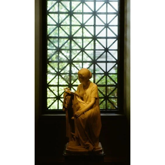 The National Gallery:

Monet. Turner. Da Vinci. Napoleon (in his study) stands over millions of visitors each year. Here, a girl reads in the dim warm light of the ground floor, surrounded by other American and European sculptures. Perhaps she reads 