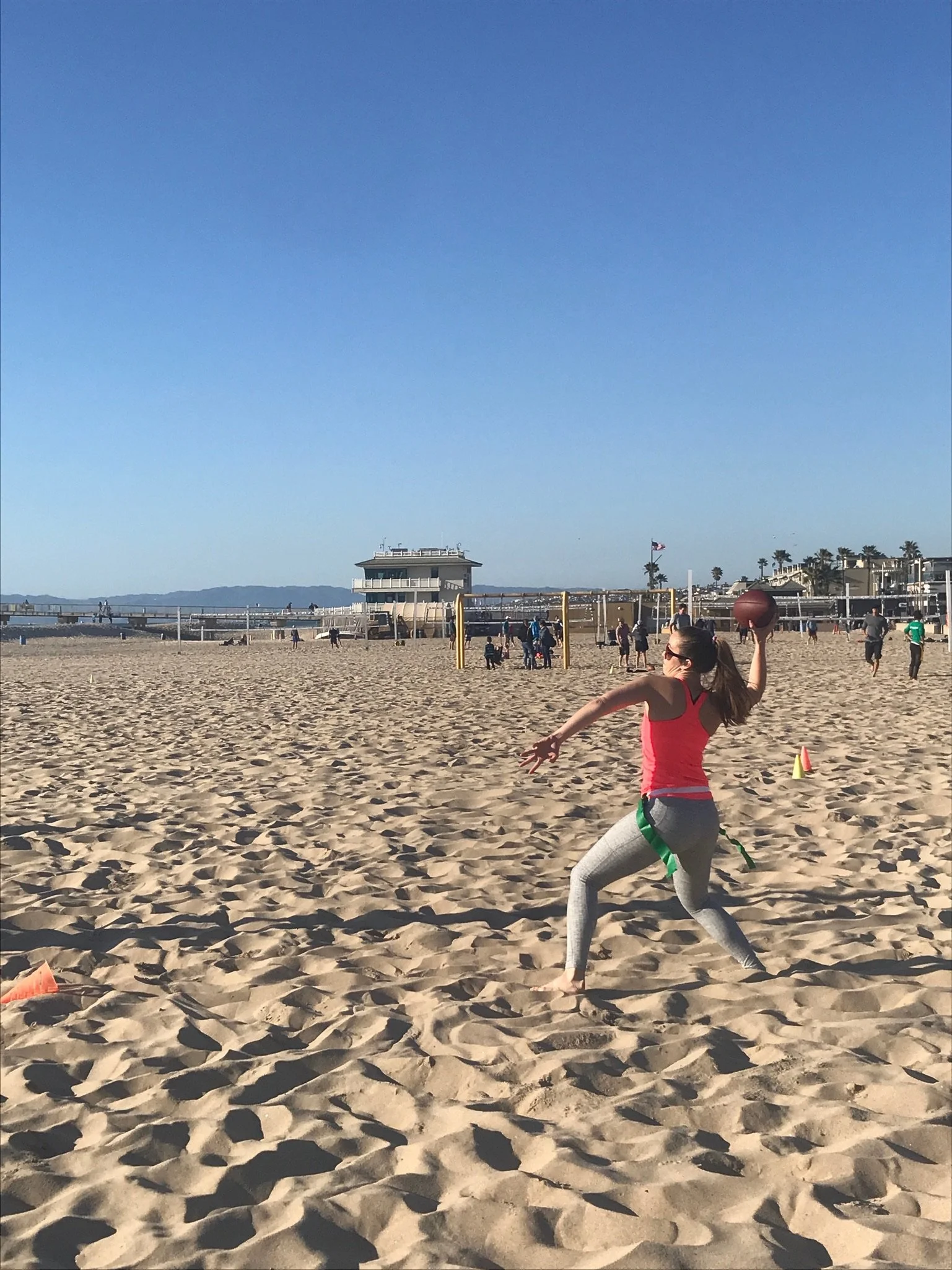 Many different women complete at the only beach flag football league on Hermosa Beach by Beach Time Sports.