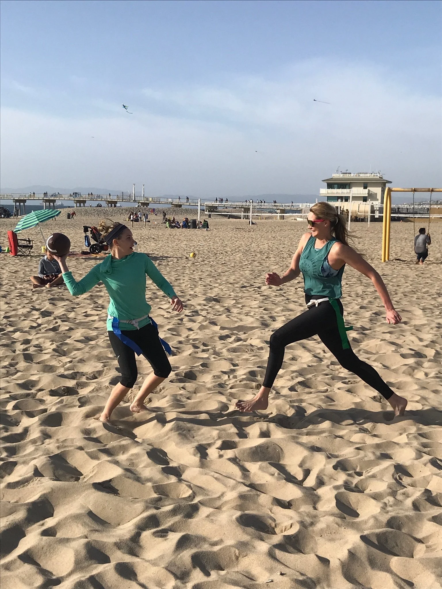Many different women complete at the only beach flag football league on Hermosa Beach by Beach Time Sports.