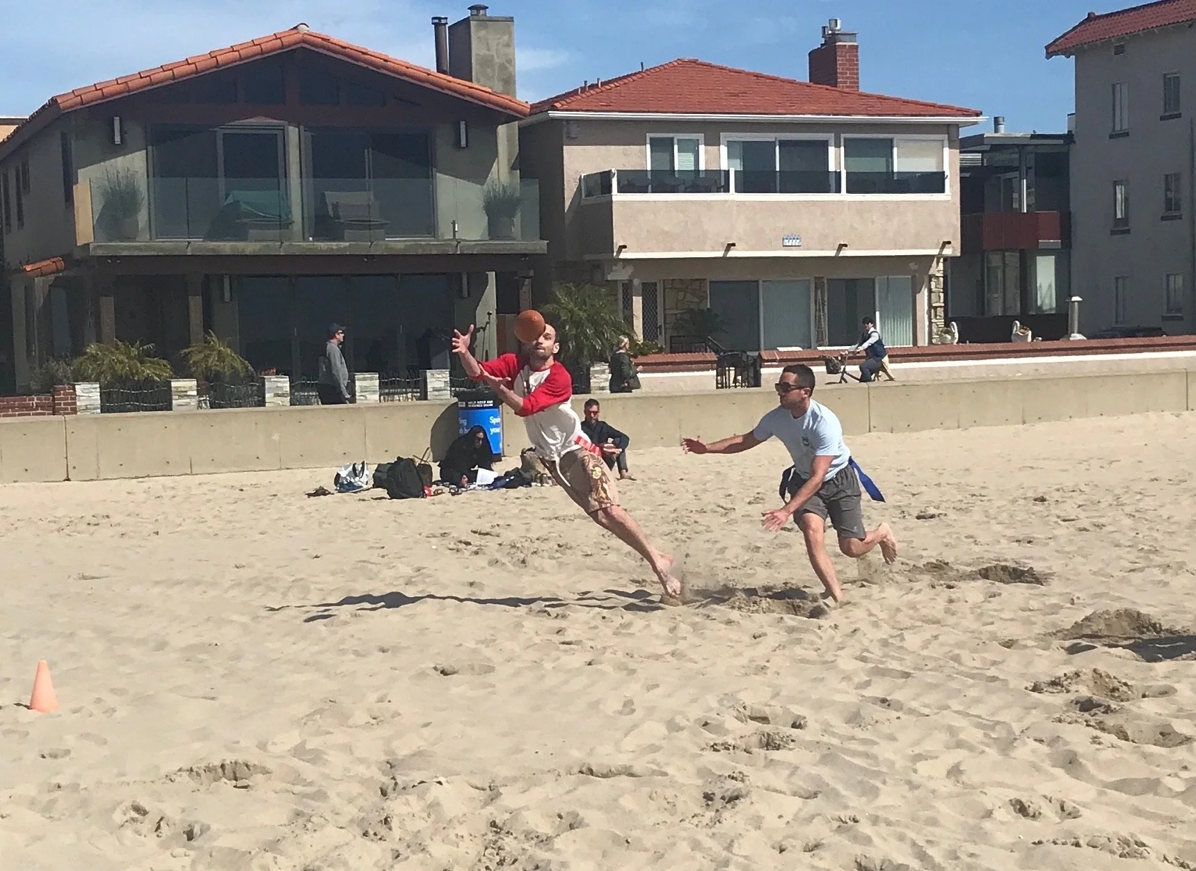Lots of fun, competition, and socializing at the only beach flag football league on Hermosa Beach by Beach Time Sports.