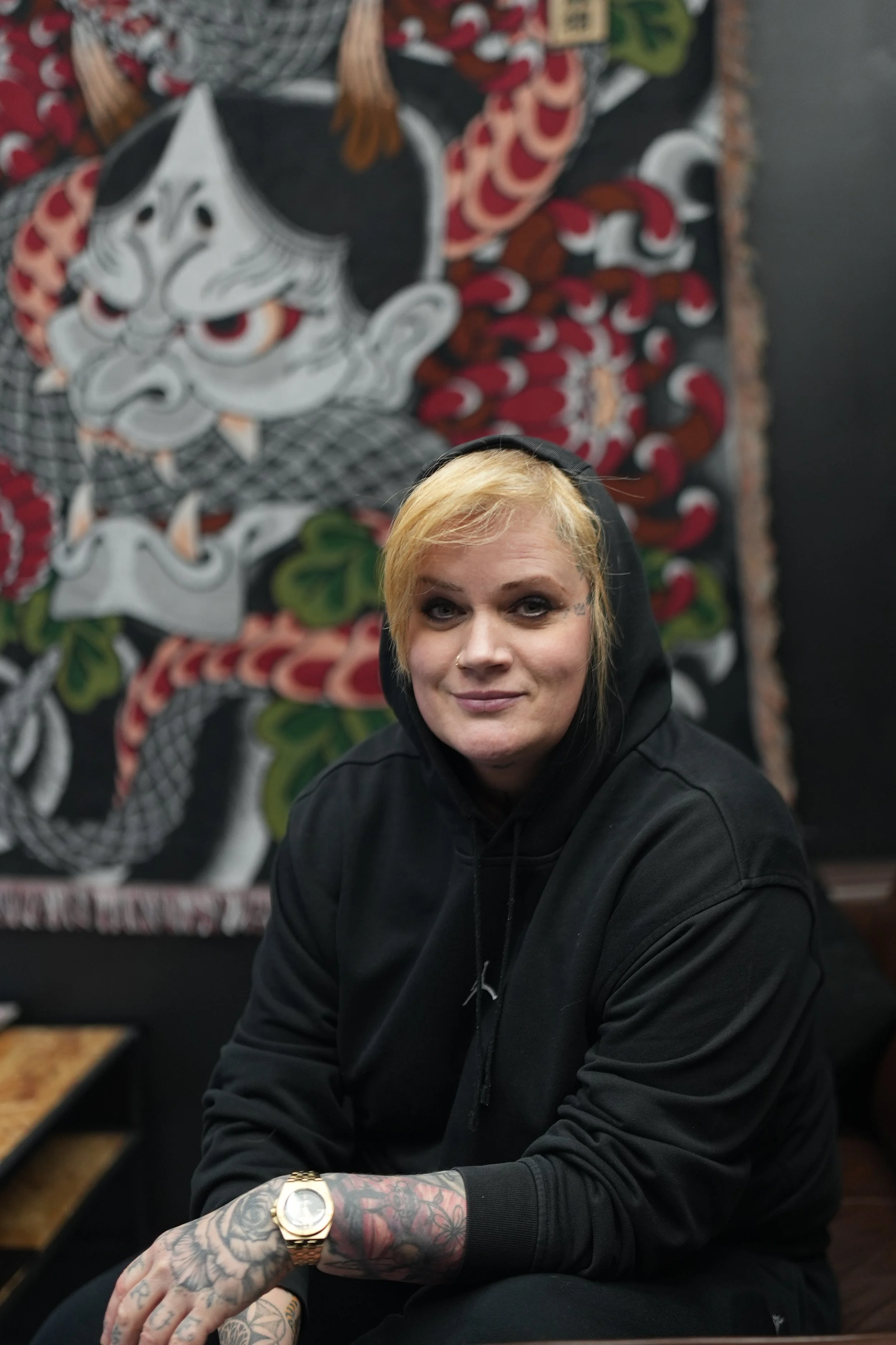 Black circular background with white graffiti-style V and E letters, a small heart, and star-like splashes.