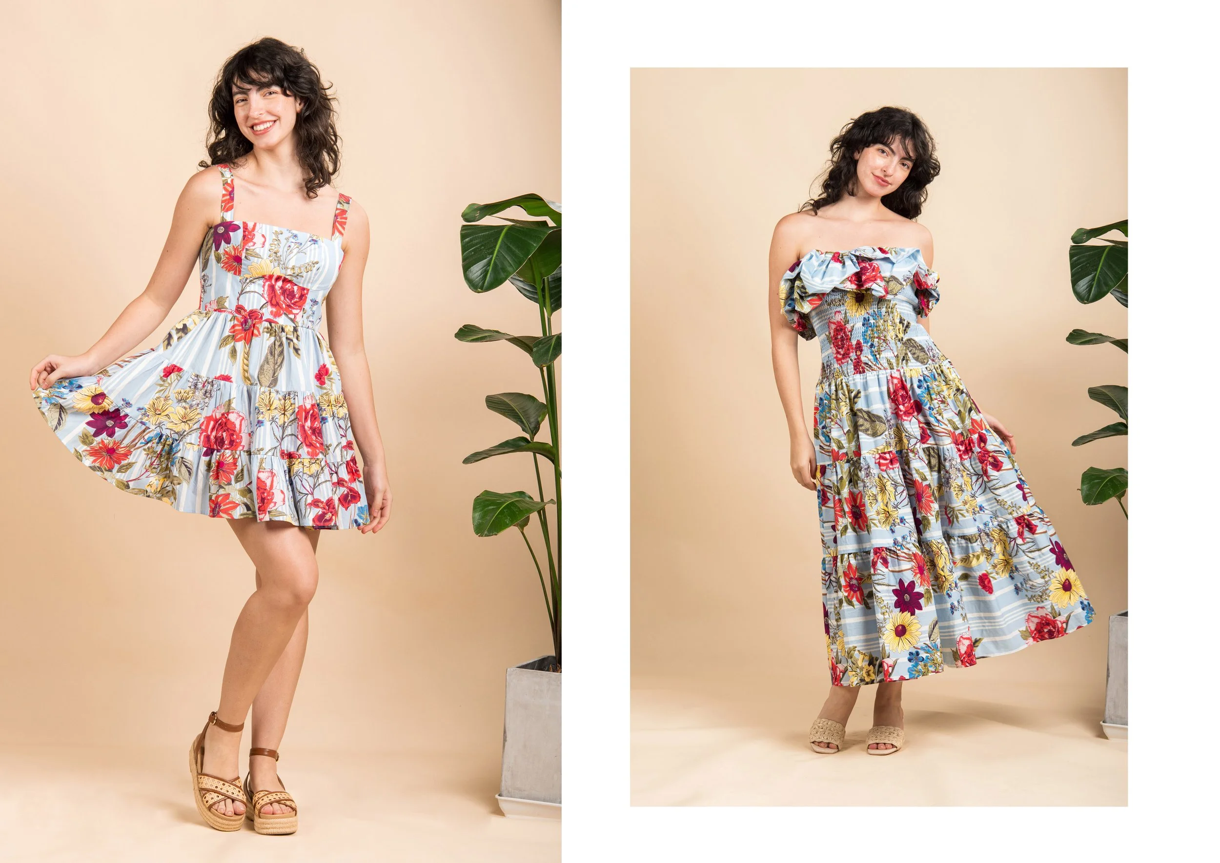 Two women standing against a beige background with green potted plants on each side. The woman on the left wears a colorful floral dress, smiling and holding out the hem, wearing tan sandals. The woman on the right wears a ruffled floral maxi dress, 