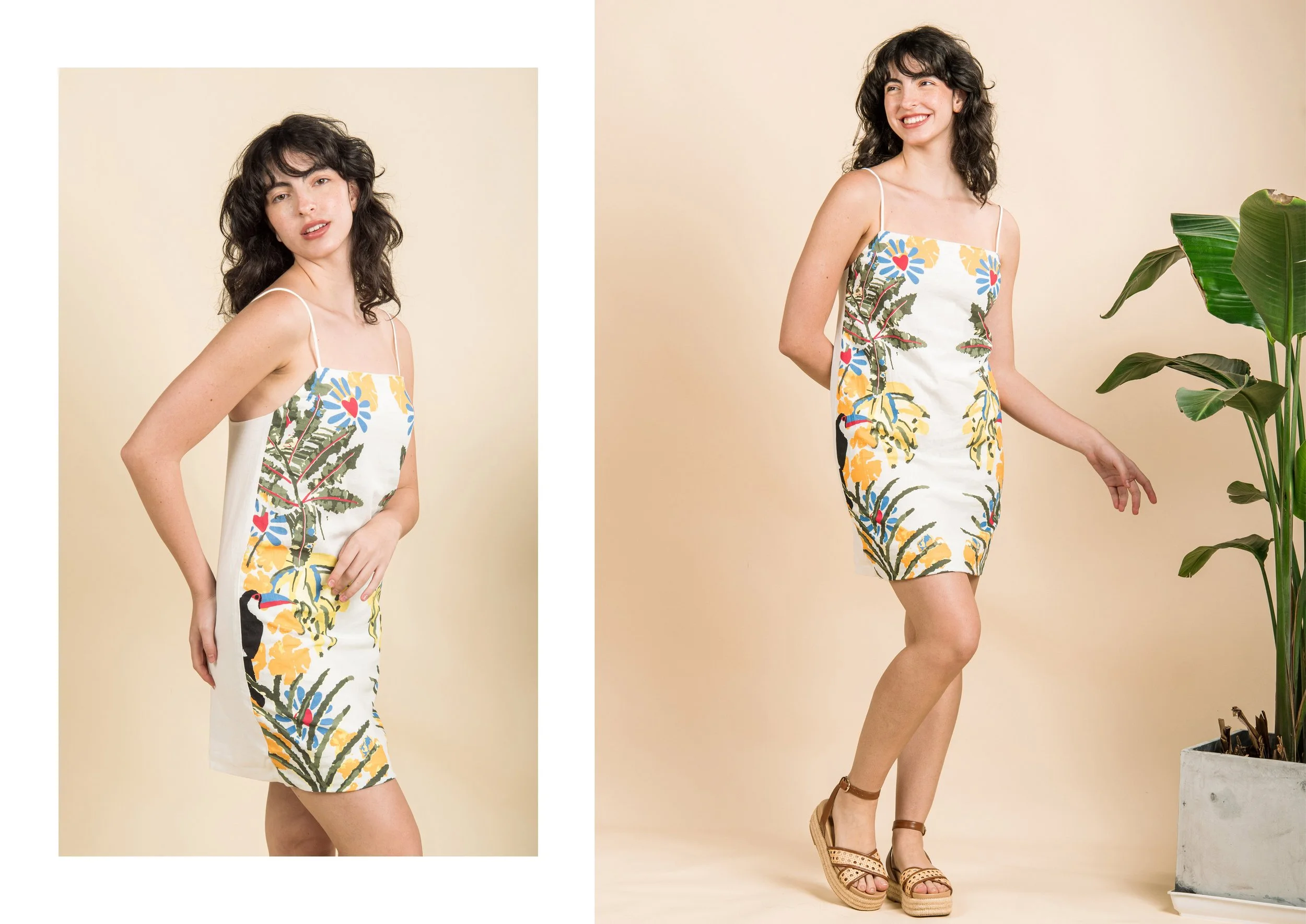 Two women in floral dresses posing against a beige background, one with hand on hip and the other smiling, near a large potted plant.
