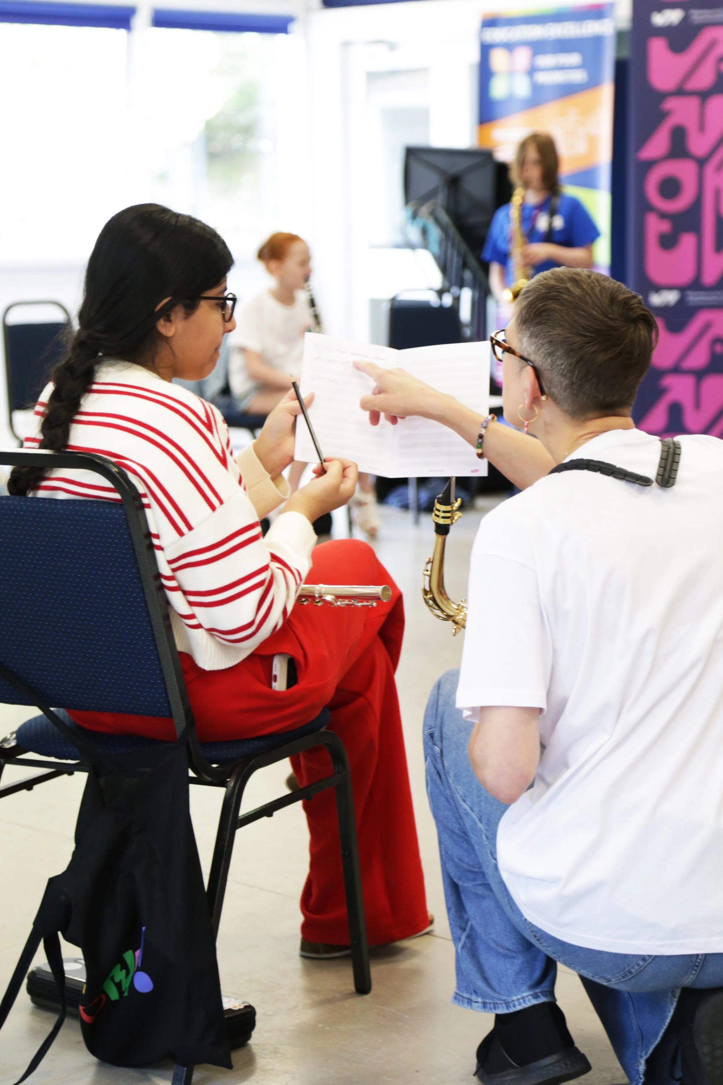 music leader kneeling next to a camp participant