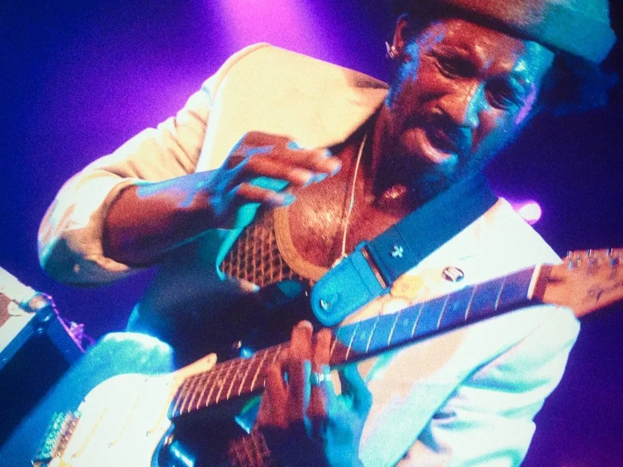 photo of a man playing guitar