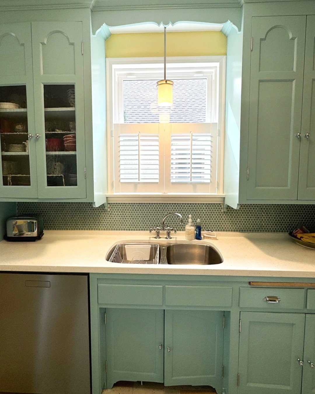 A sweet little cafe shutter in this fun kitchen provides just the right amount of light filtering and privacy! Shutters are durable, practical, and add an elevated style to any window. Give us a call today and we will take care of the measuring, help