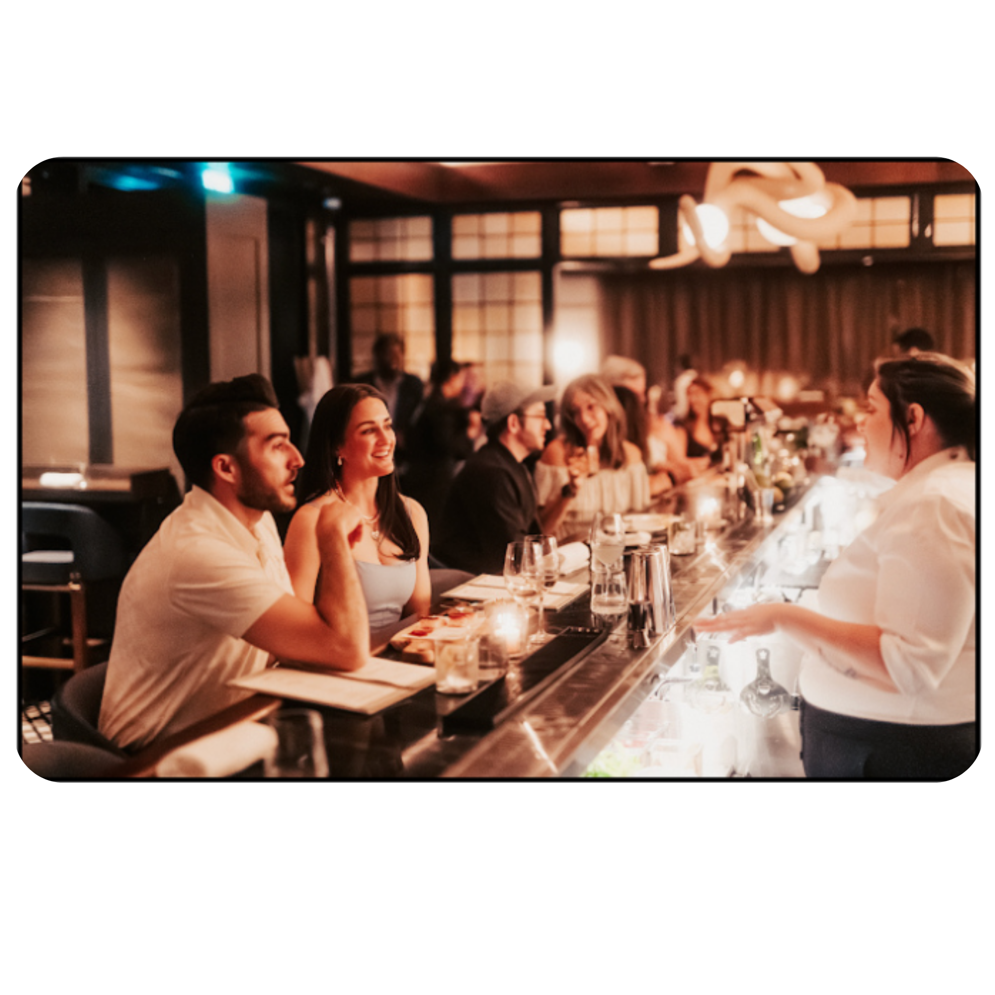 People dining at a restaurant with Japanese decor, including shoji screens and traditional wooden accents.