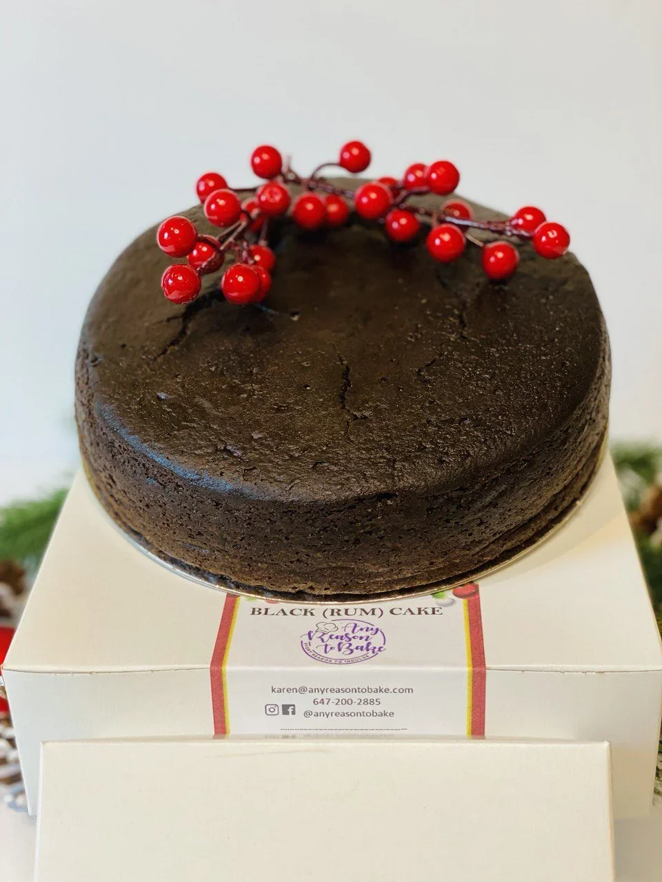 Chocolate cake with red berry decoration on top. | Any Reason To Bake
