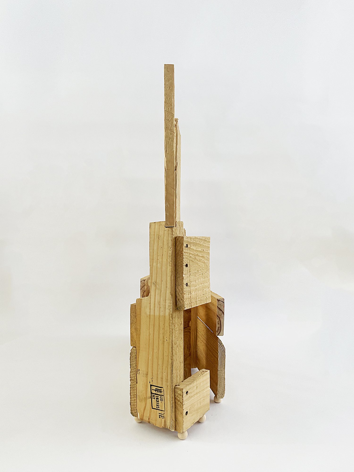 Untitled (Three Graces), 2025, 37h x 32w x 11d - salvaged wood pallet, wood balls {feet}, threaded rod, epoxy, wood glue, dowels