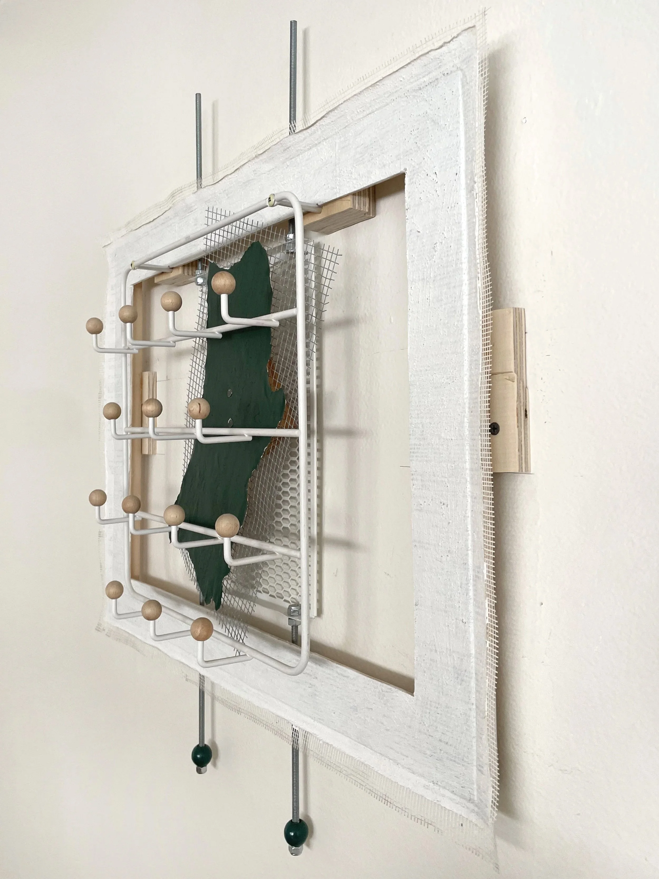 Untitled (french market), 2025-2026, 28h x 26.5w x 5d - salvaged barricade paper from the closed French Market restaurant, Ikea shelving, pre-mounted wood panel, prescription drug legal disclaimers, construction mesh, sheet rock tape, threaded rod, w