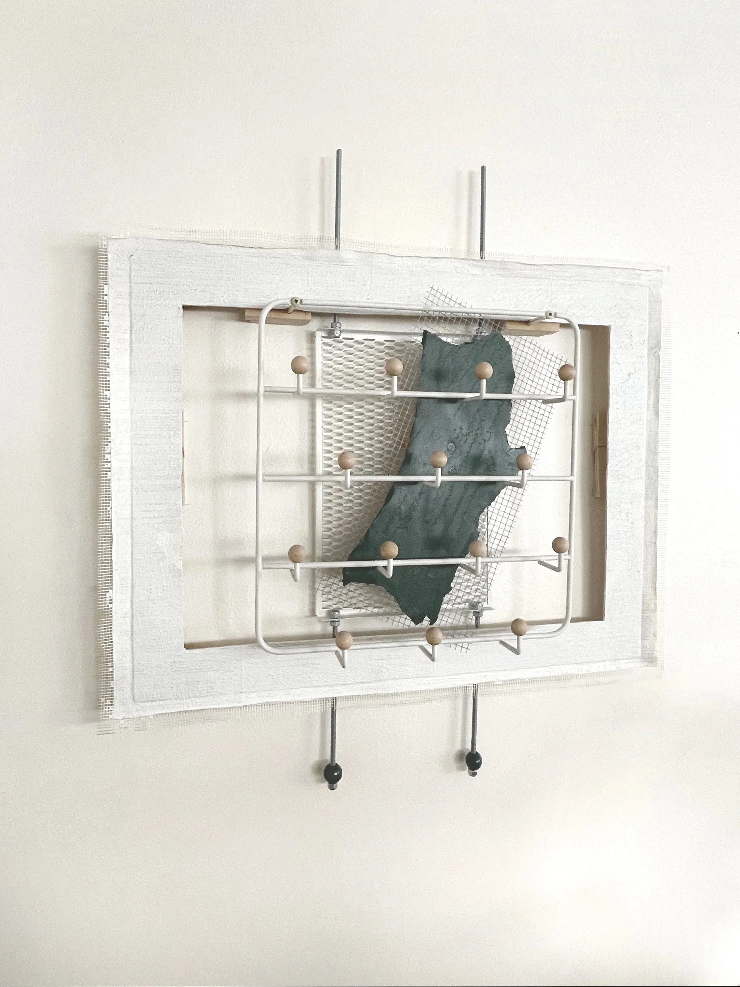 Untitled (french market), 2025-2026, 28h x 26.5w x 5d - salvaged barricade paper from the closed French Market restaurant, Ikea shelving, pre-mounted wood panel, prescription drug legal disclaimers, construction mesh, sheet rock tape, threaded rod, w