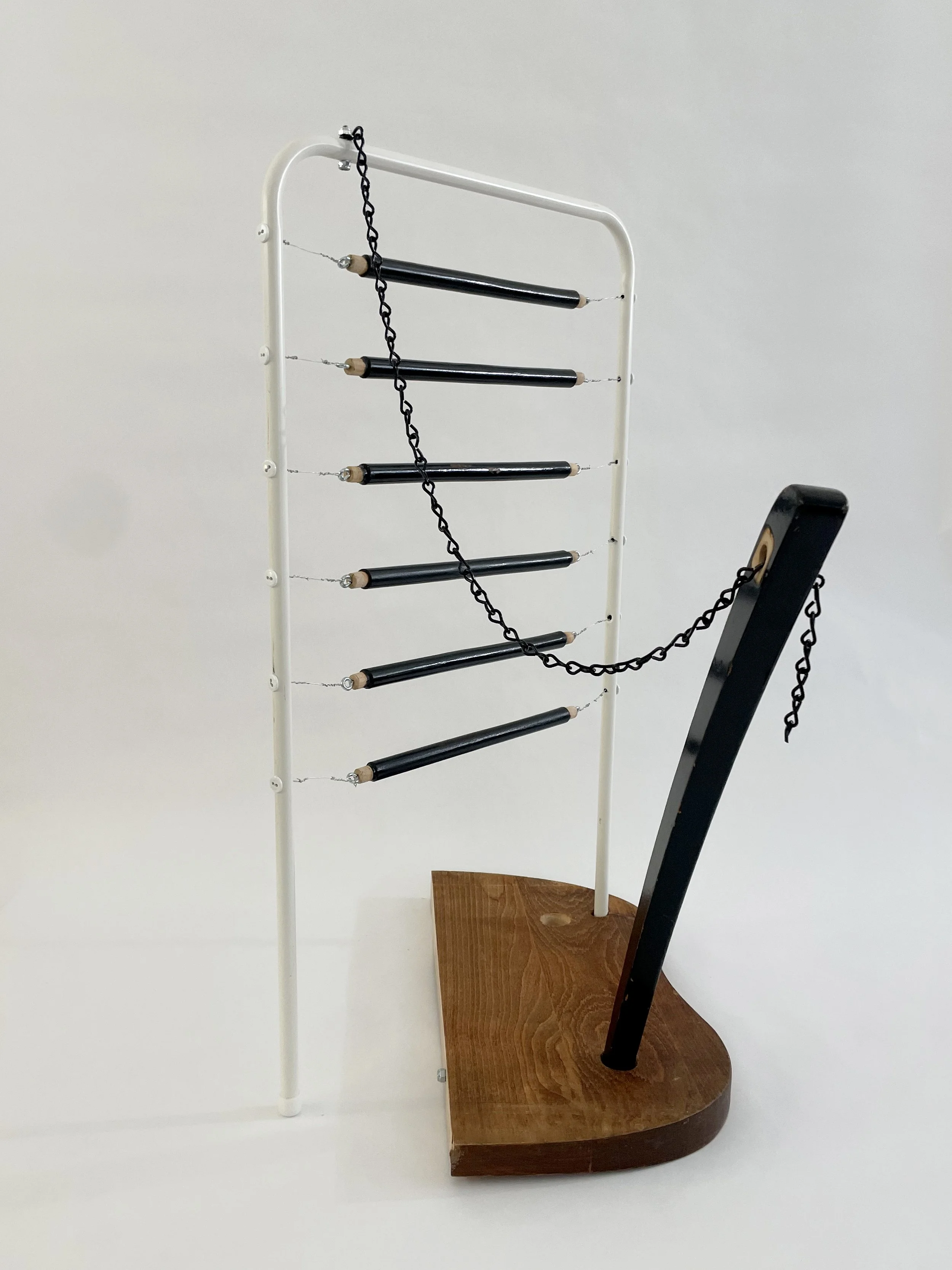 Untitled (harp), 2026, 26.5h x 21w x 13.5d - salvaged wood spindles, furniture leg, oak chair seat, Ikea aluminum legs, black zinc chain, buttons, wire, threaded rod, lock knots