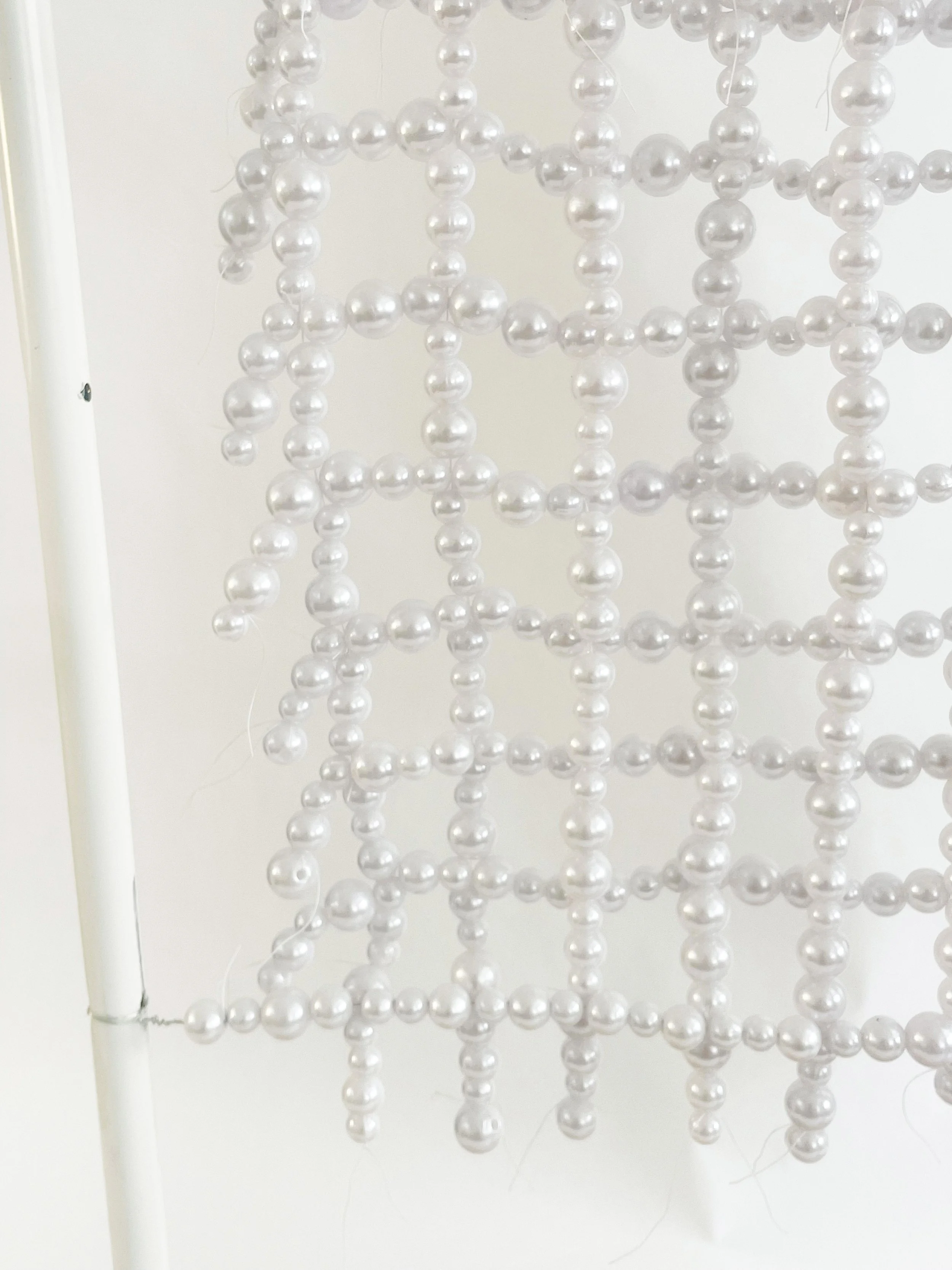 Untitled (radiator), 2026, 28h x 24x x 11d - salvaged turned wood, Ikea aluminum legs, plastic pearl beads, found plywood, wire, thread, thread rod