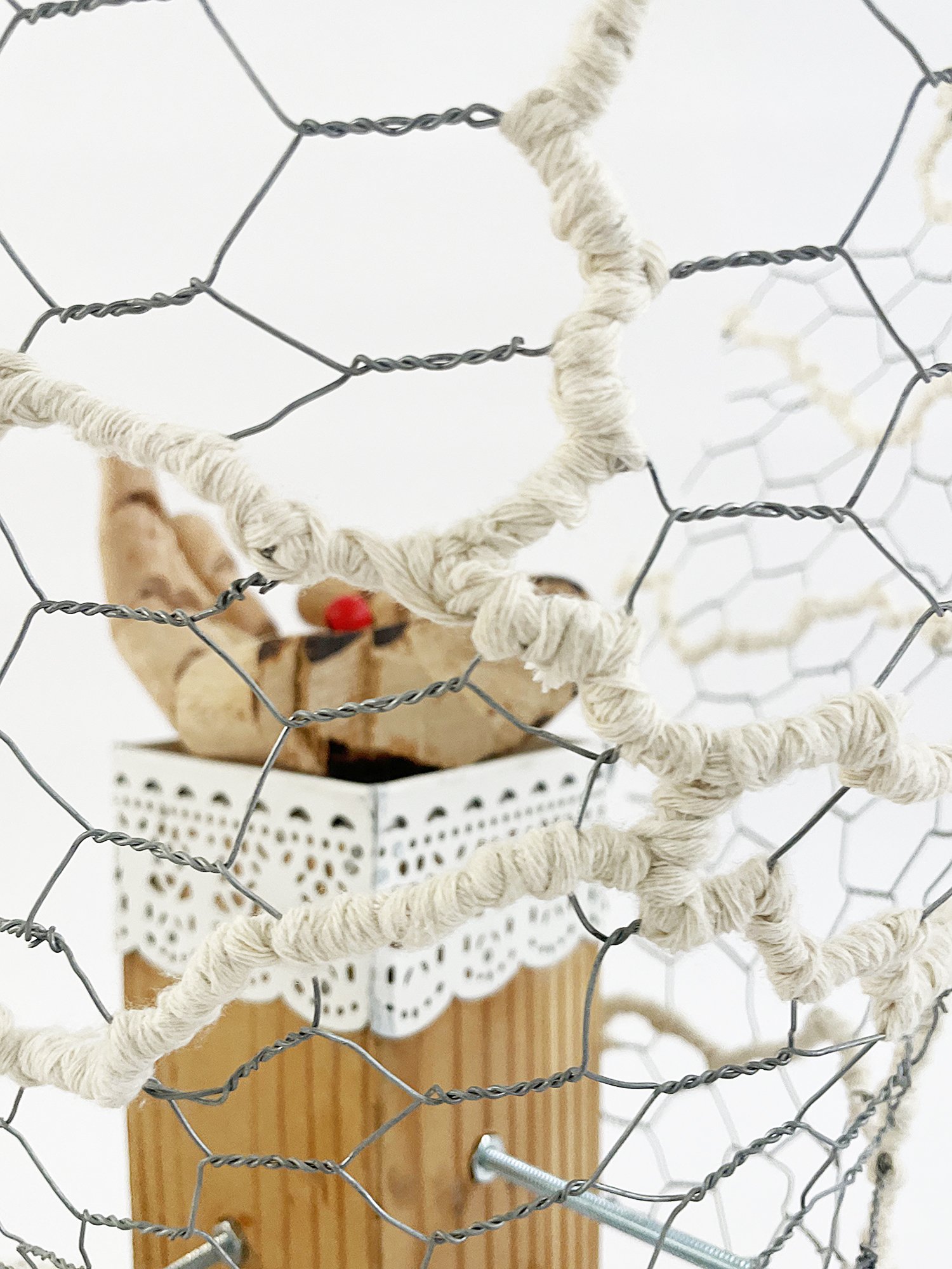 Untitled (Logan's Clock), 2025, 19h x 14w x 14d - salvaged plywood,4x4 lumber, walnut veneer, wood pegs {feet}, Ikea wooden model hand, chicken wire, butcher's string, Ikea metal trim, cotton fabric, threaded metal rod, wood beads, nuts, washers,