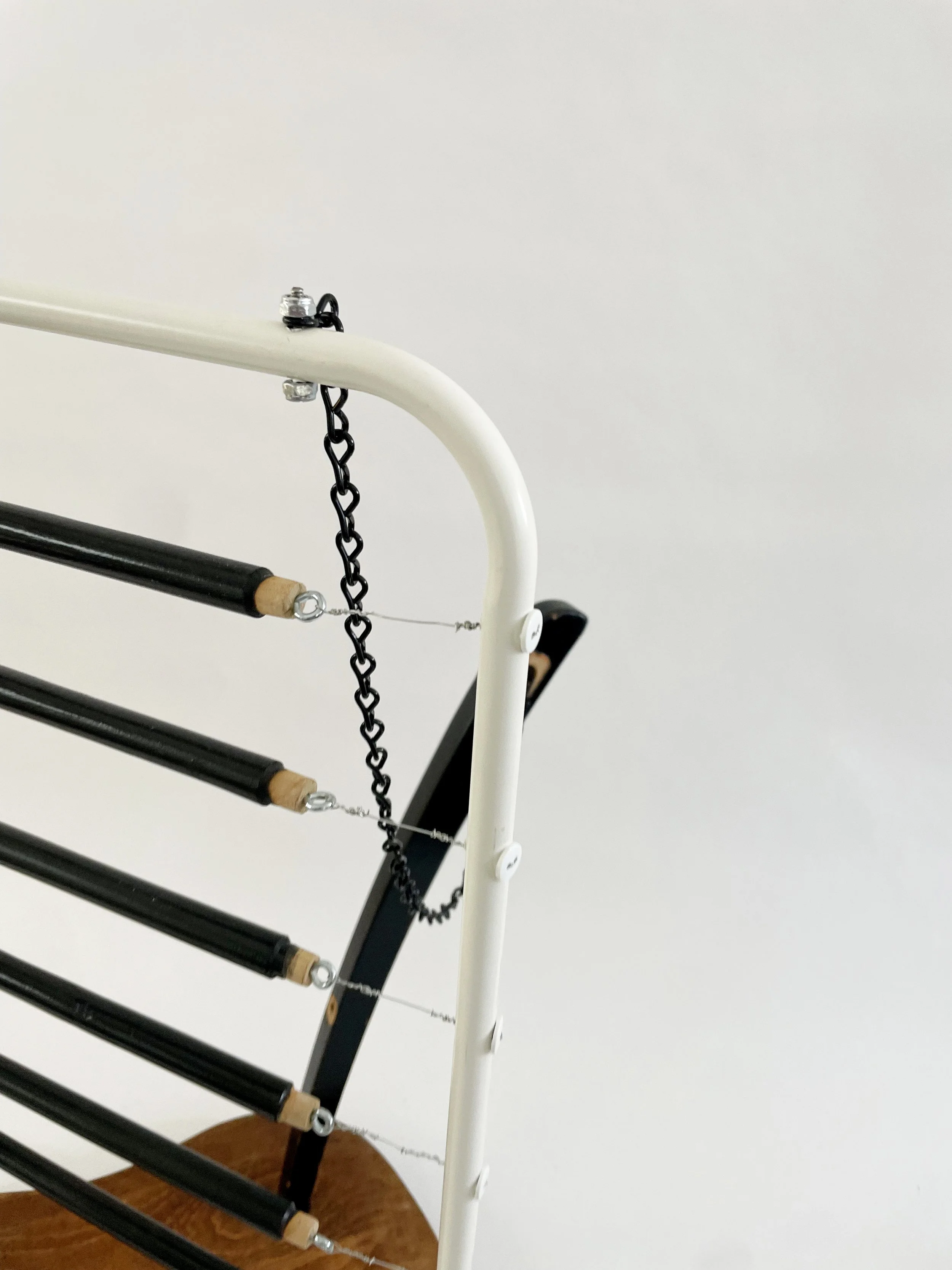 Untitled (harp), 2026, 26.5h x 21w x 13.5d - salvaged wood spindles, furniture leg, oak chair seat, Ikea aluminum legs, black zinc chain, buttons, wire, threaded rod, lock knots