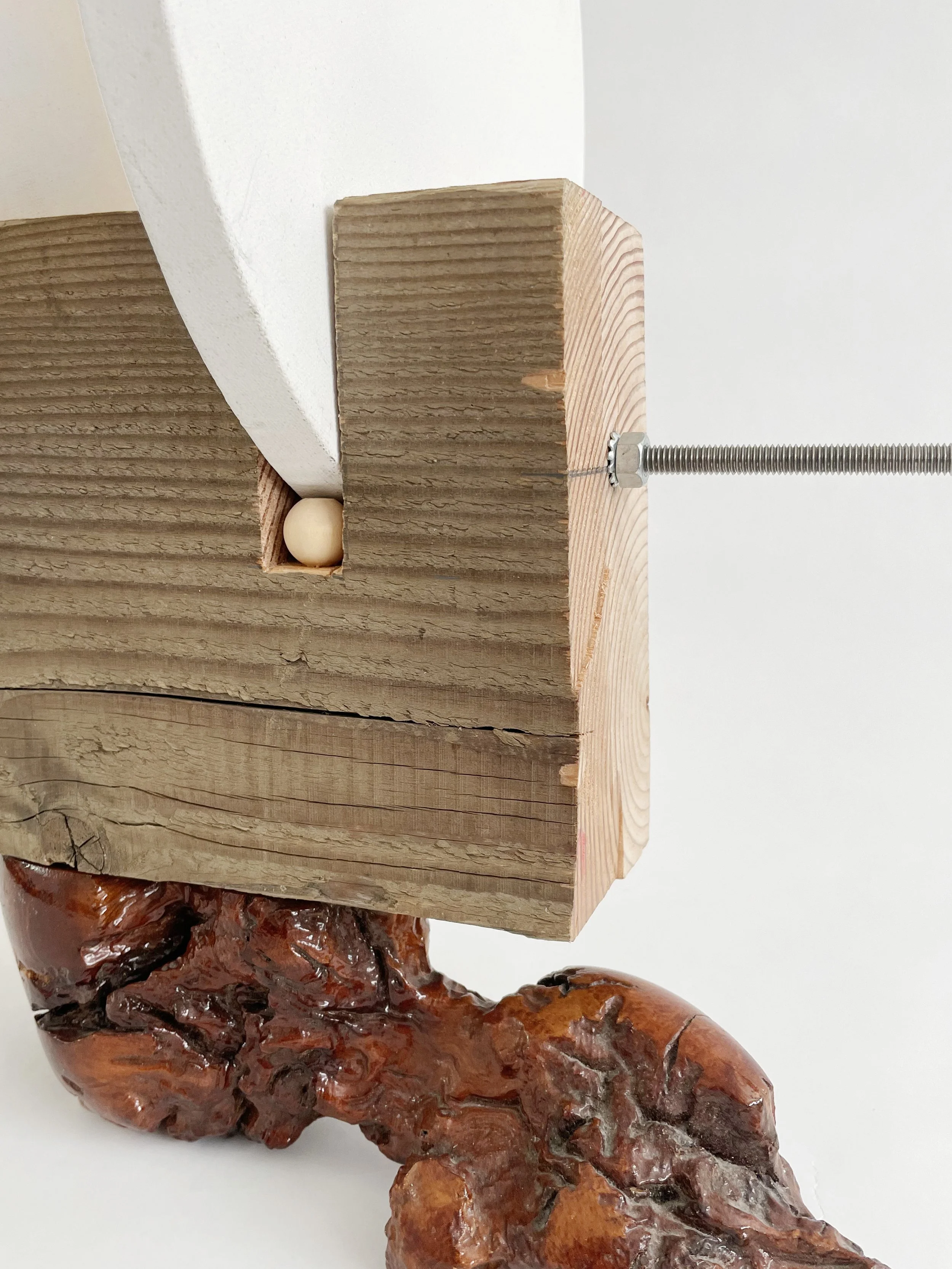 Untitled (two disks) 2025- 2026, 19.5h x 16w x 22d - thrift store resin coated driftwood, 3x7 construction timber, threaded rods, lock nuts, 2 pre-primed round stretched canvas, wood finials, dowels, wood beads.