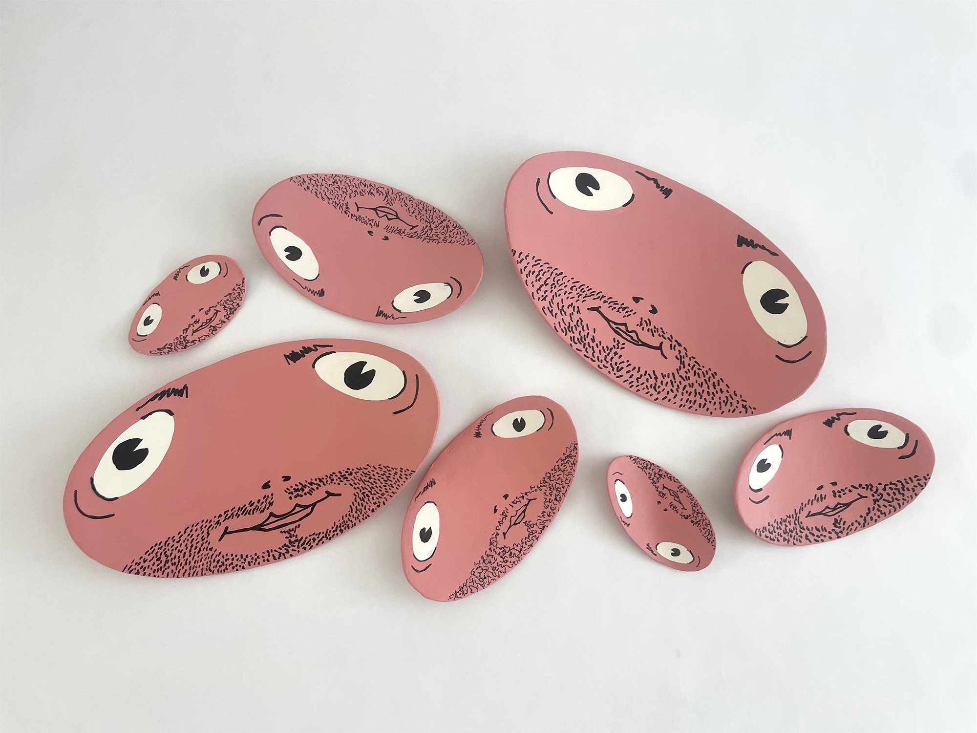 Seven floppy faces. Sizes vary from 8 3/4 x 5 1/2 to 3 x 1 3/4, cardboard, acrylic, medium, acrylic, gouache, pigment ink and acrylic paint pen, ColorAid paper, glue, 2026 {front}