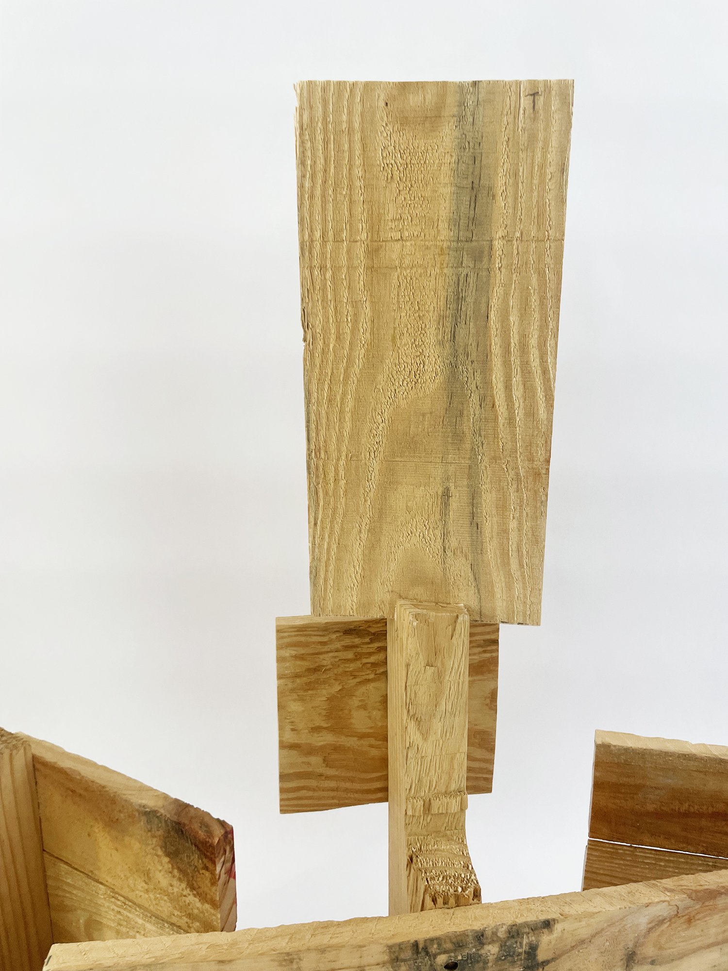 Untitled (Three Graces), 2025, 37h x 32w x 11d - salvaged wood pallet, wood balls {feet}, threaded rod, epoxy, wood glue, dowels