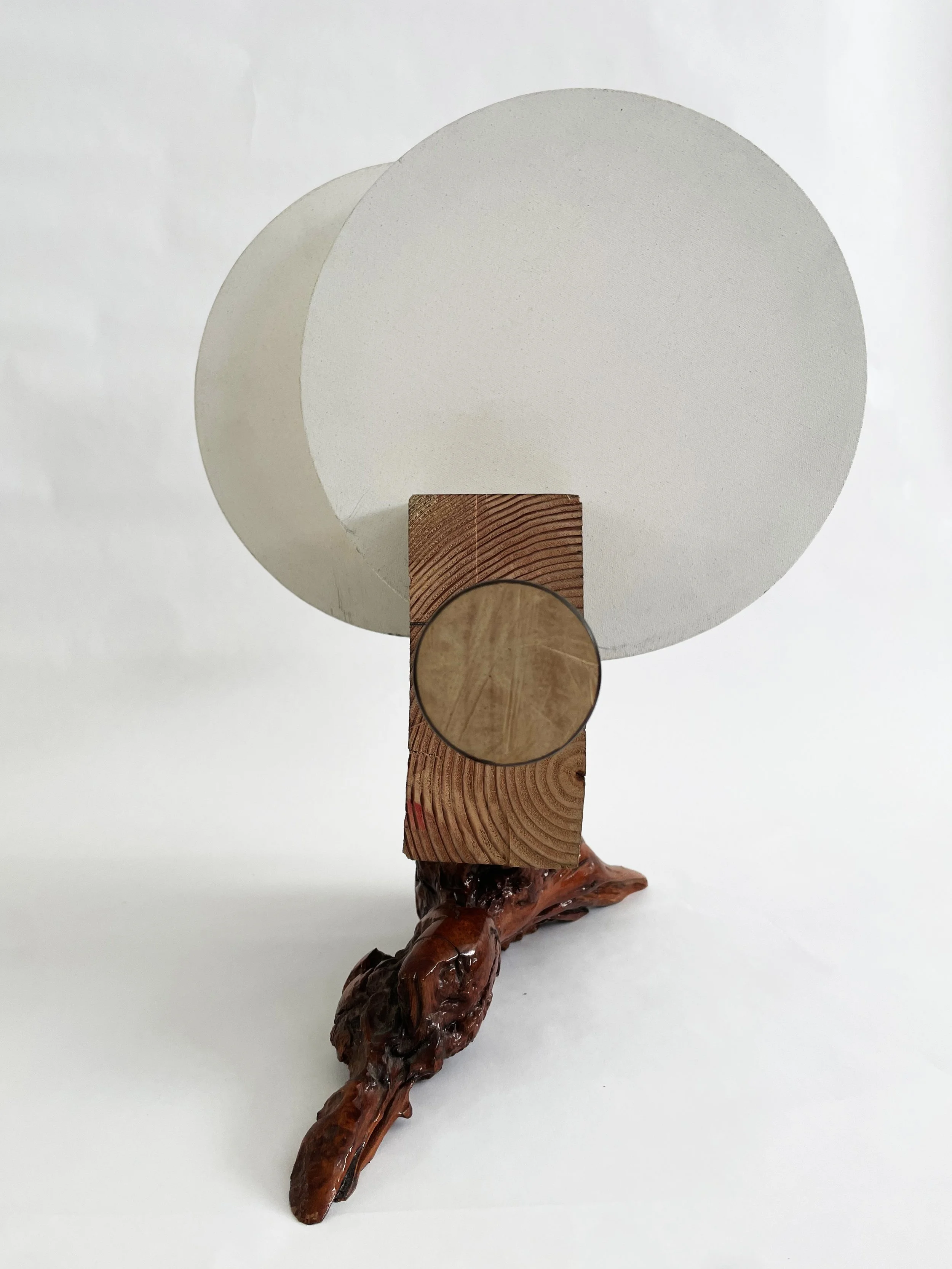 Untitled (two disks) 2025- 2026, 19.5h x 16w x 22d - thrift store resin coated driftwood, 3x7 construction timber, threaded rods, lock nuts, 2 pre-primed round stretched canvas, wood finials, dowels, wood beads.