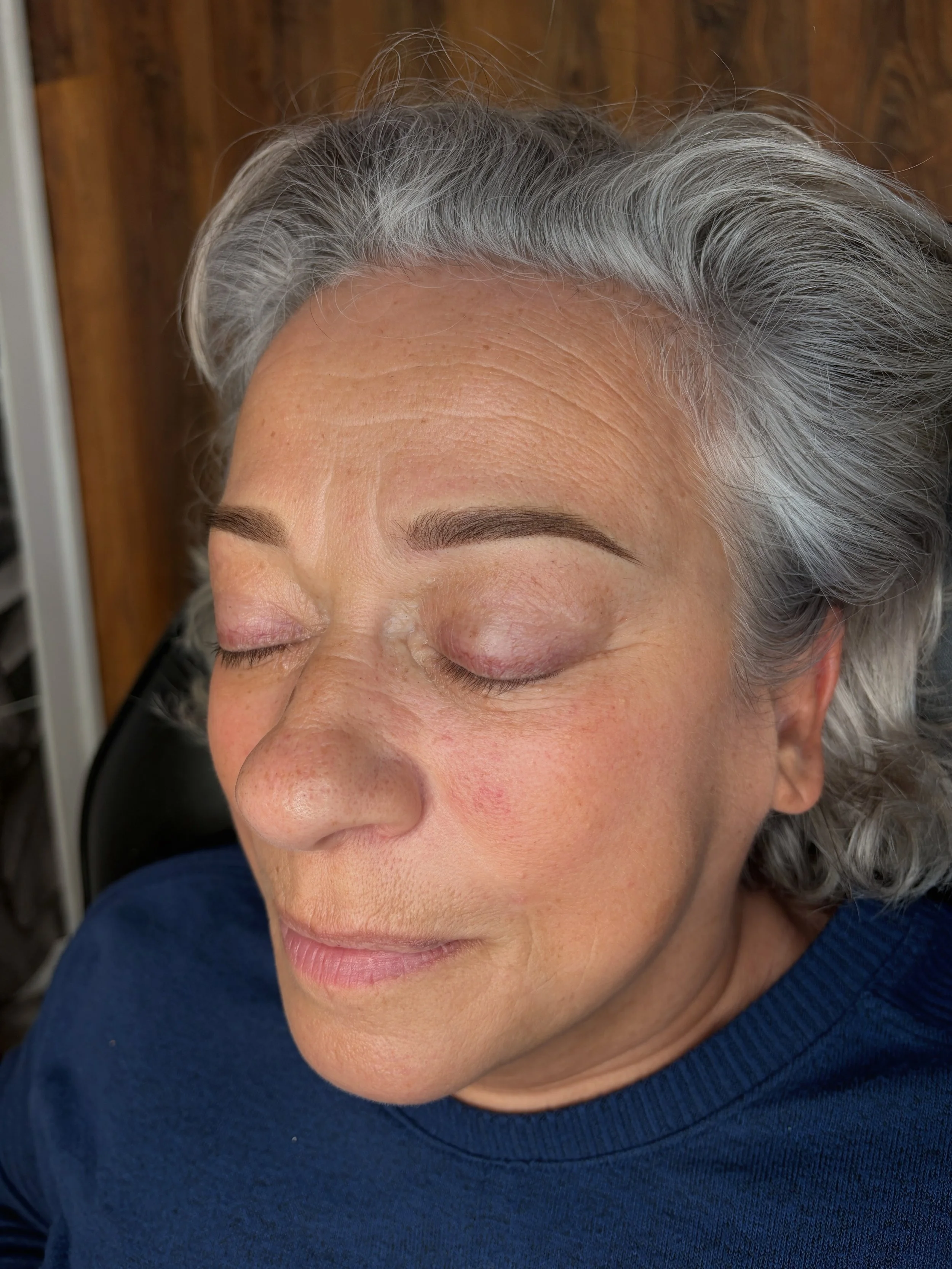 Fresh Powder Brows on a grey-haired client, showing defined arches immediately after treatment.