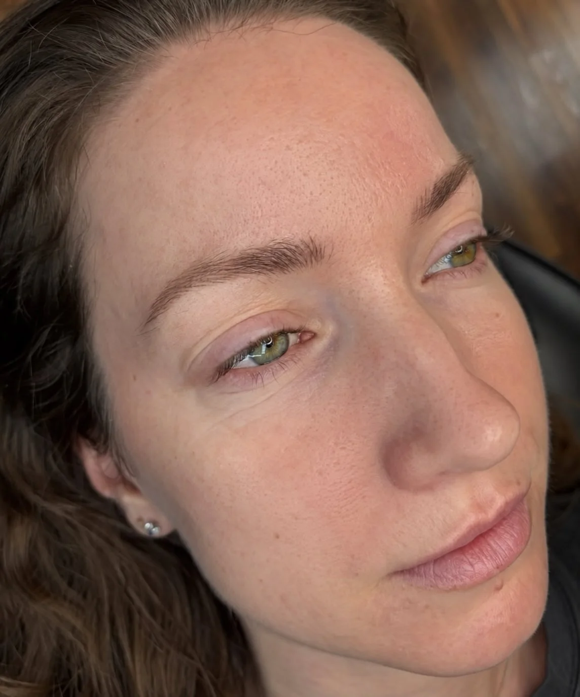 Close-up of Nano Brows showing fine hair-like strokes blended with natural eyebrow hairs.