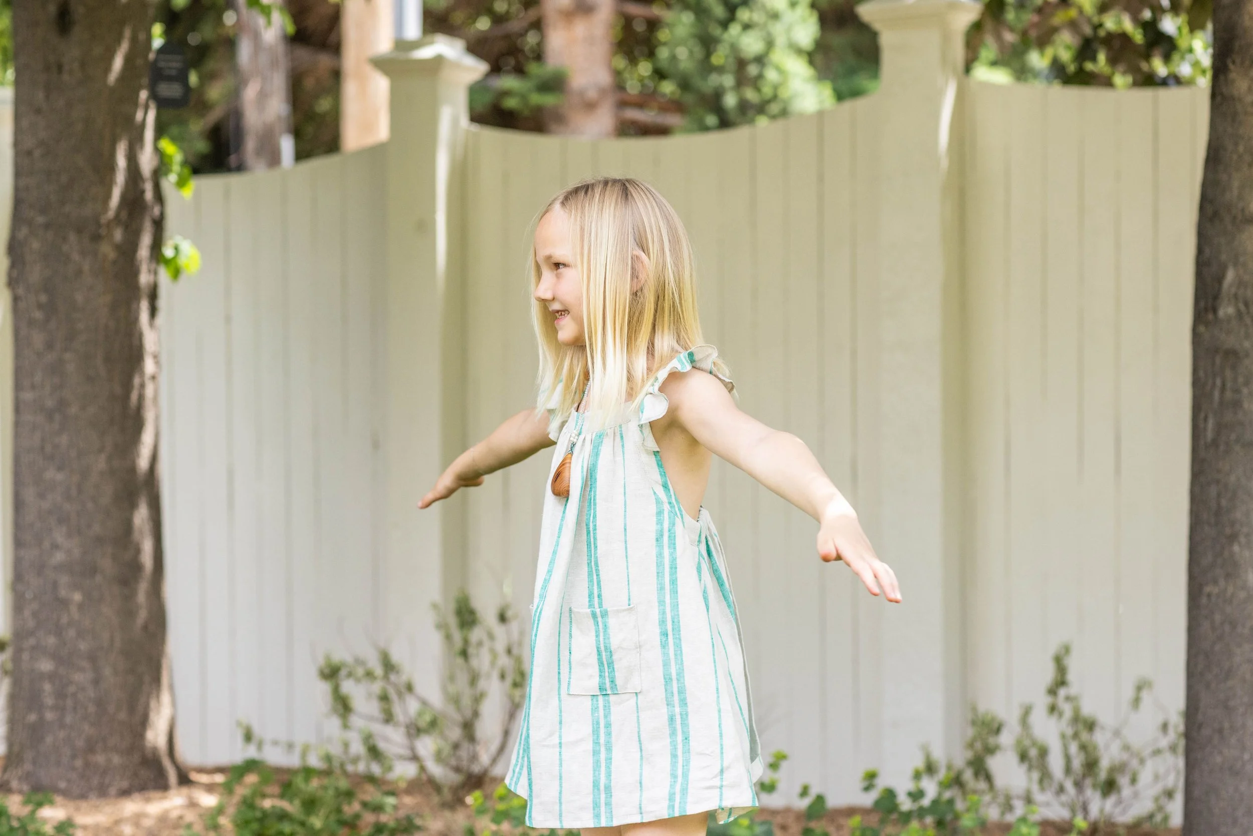 Foxlilie-girl-ivy-ruffle-dress-jade-stripe-lifestyle-side.jpg