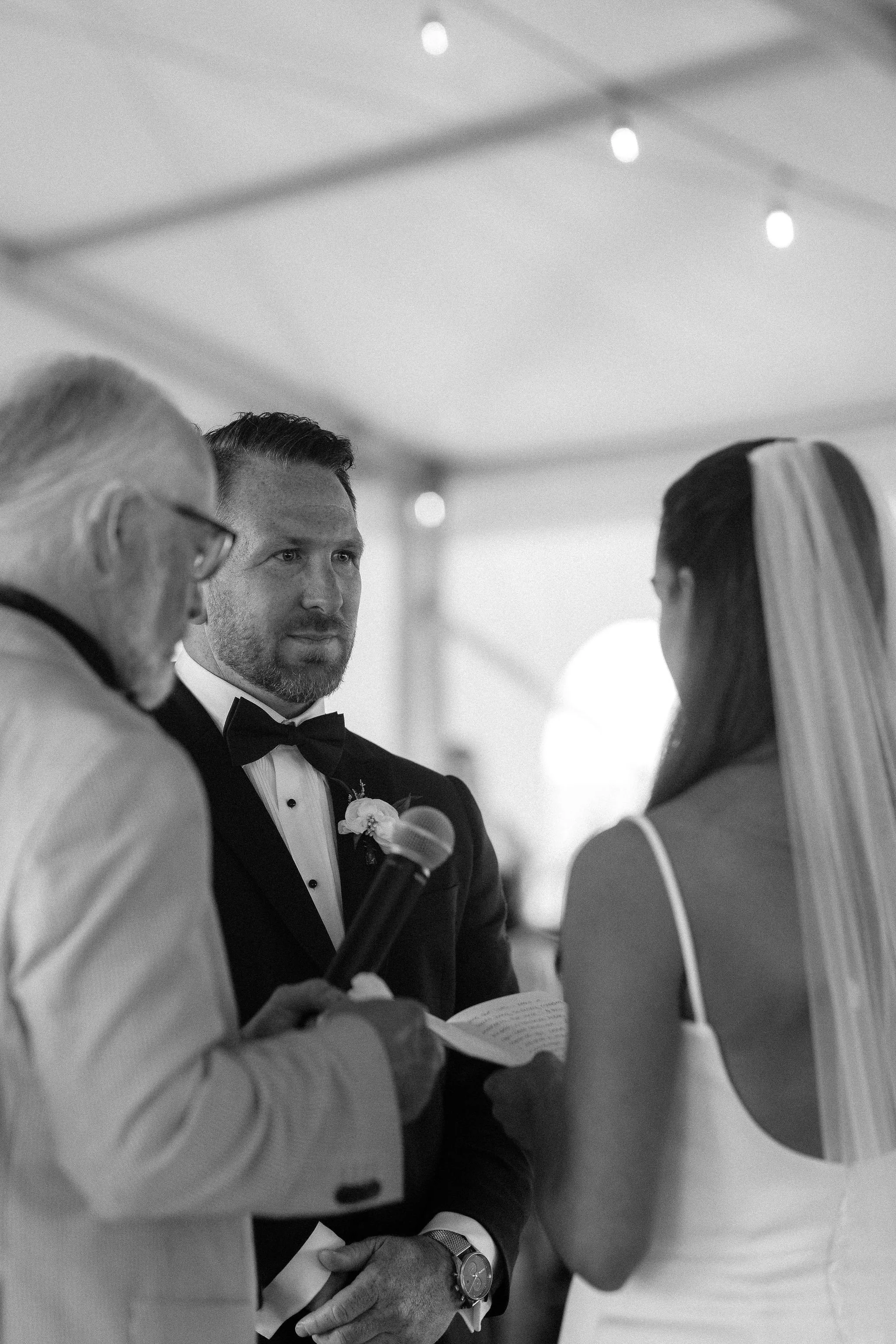 A wedding ceremony inside a large white tent, Calgary Alberta.