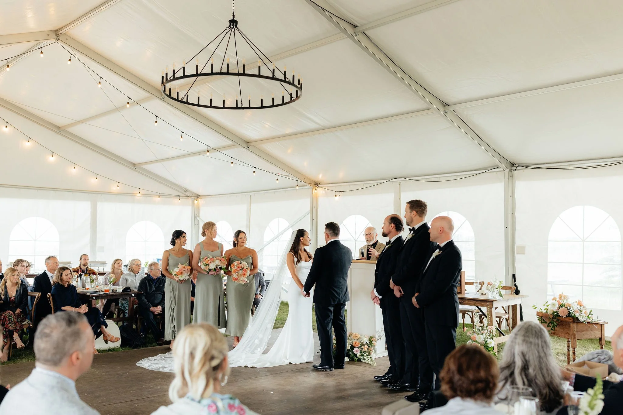 A wedding ceremony inside a large white tent, Calgary Alberta.