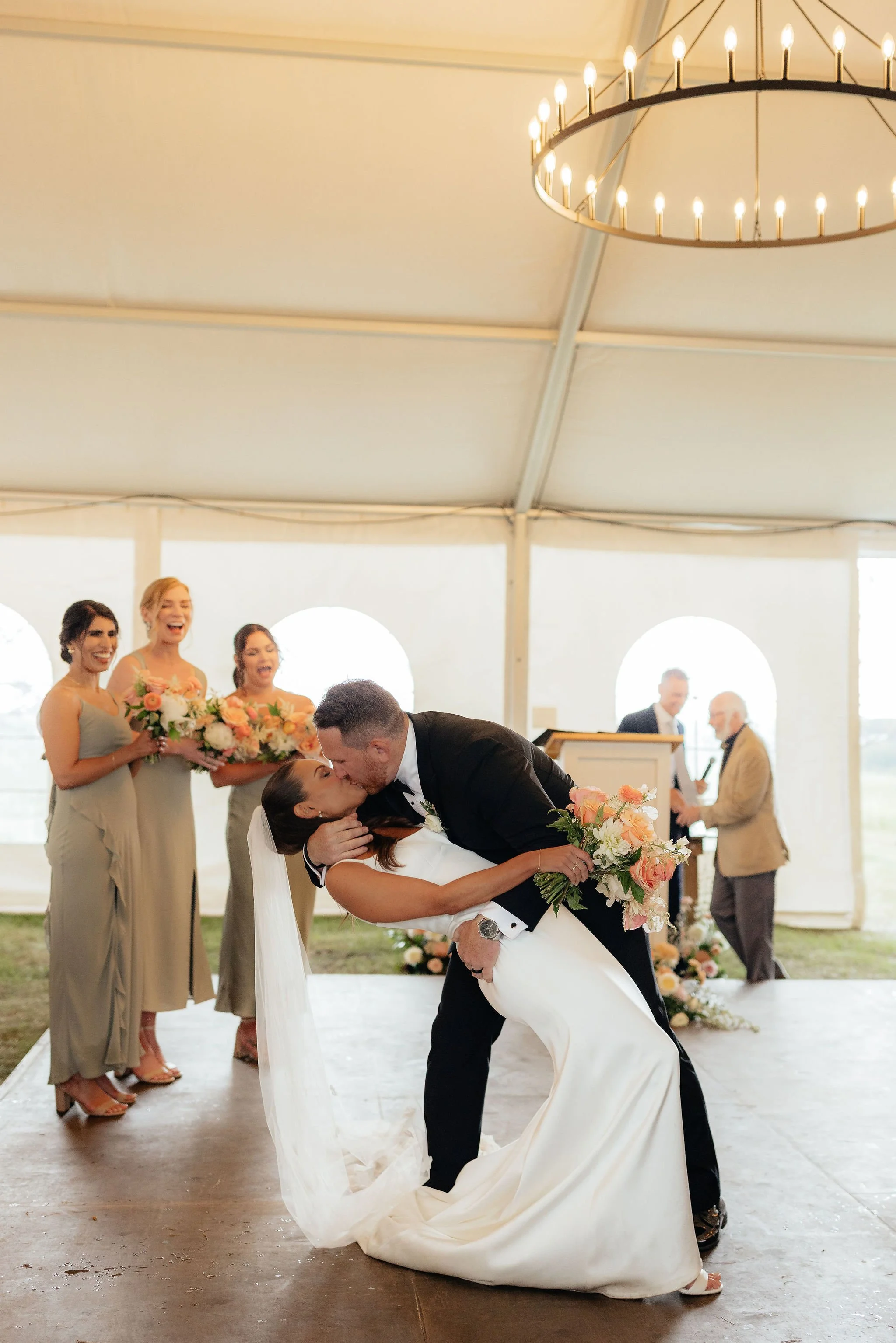 A wedding ceremony inside a large white tent, Calgary Alberta.