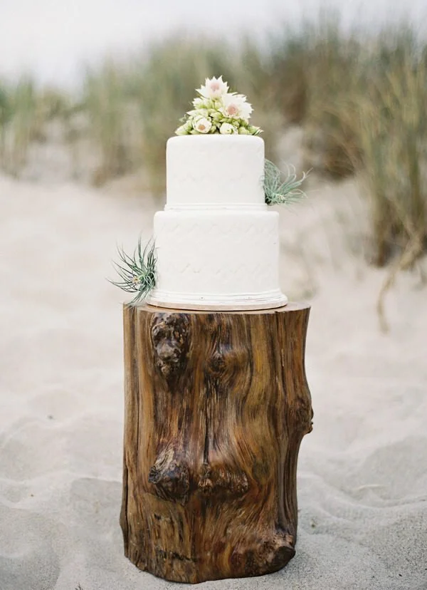 beach wedding cake on sand.jpg