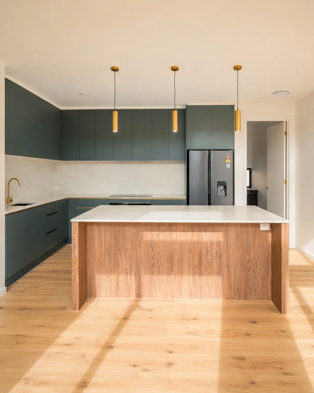The heart of this home is not a room.

It is one carefully designed space.

The kitchen island does so much more than add extra bench space.

It becomes the natural connection point between the kitchen, dining, and living areas, making it easy to coo