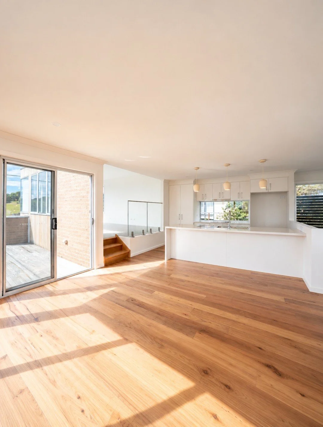 The kitchen is where life tends to land.

School bags.
Coffee cups.
Dinner prep.
Conversations that start while someone is standing at the island.

So it cannot feel disconnected from the rest of the home.

Here, the kitchen sits at the centre of the