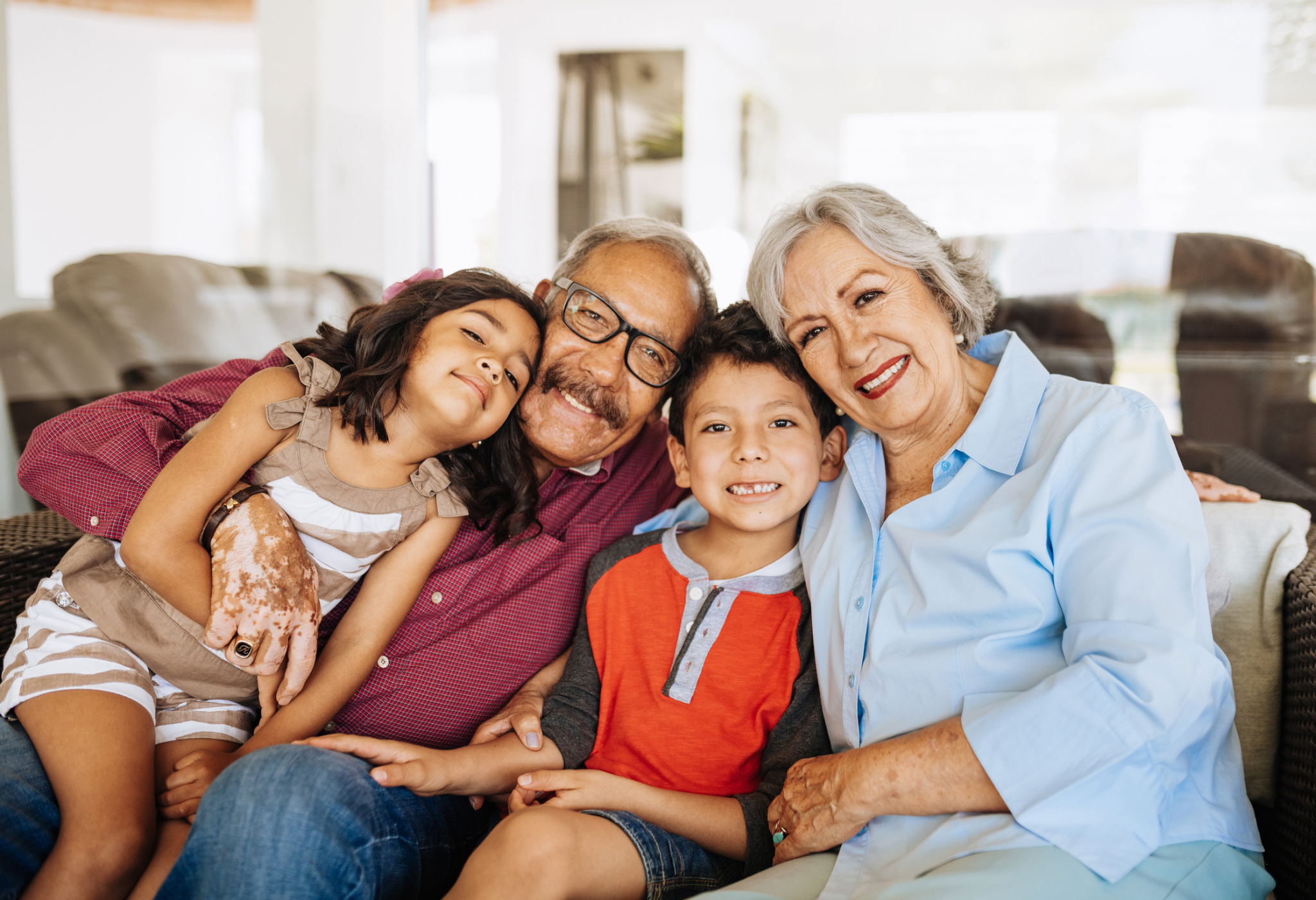 Grandparents embracing their grandchildren.