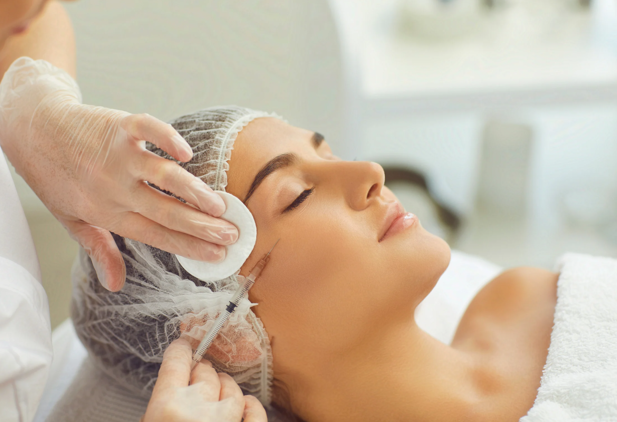 Woman getting Botox treatment in her cheeks.d