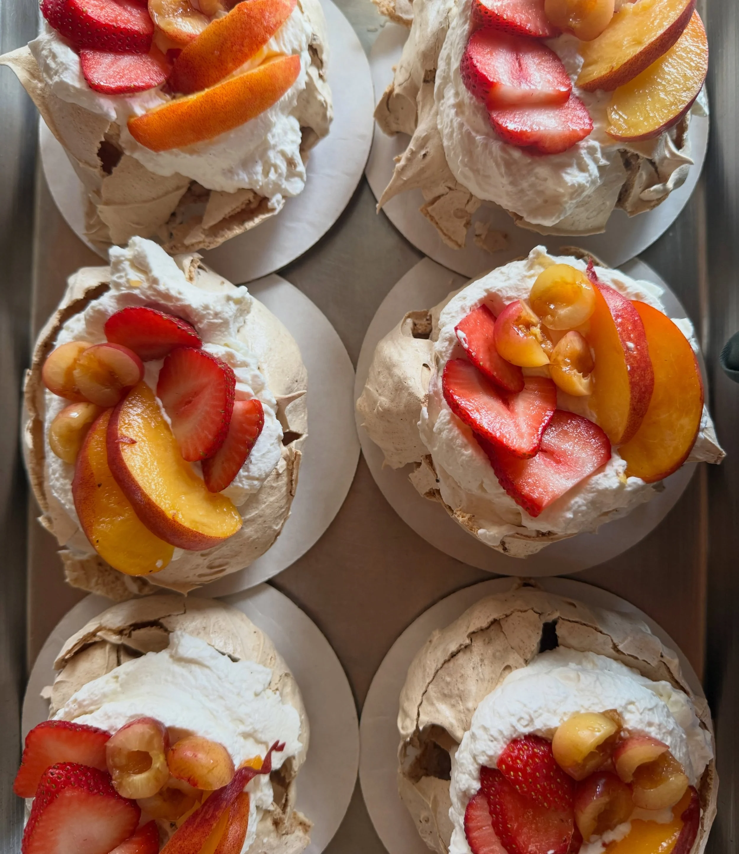 I may be nuts for this one but&hellip; all week in the case! Strawberry pavlova topped with mascarpone whip, strawbs, Rainier cherries, and yellow peaches. All my efforts this week is spent on slicing perfect fresh fruits for y&rsquo;all. 🍑🍒🍓😘
.
